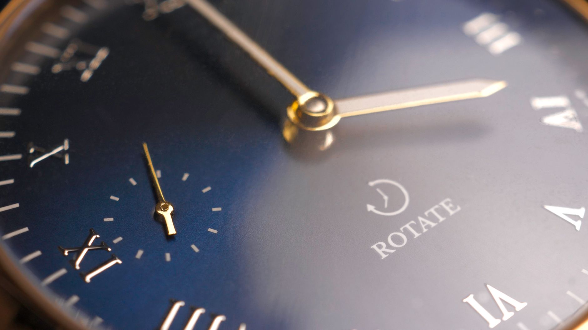 Elegant close-up of a gold analog wristwatch with Roman numerals and clock hands.