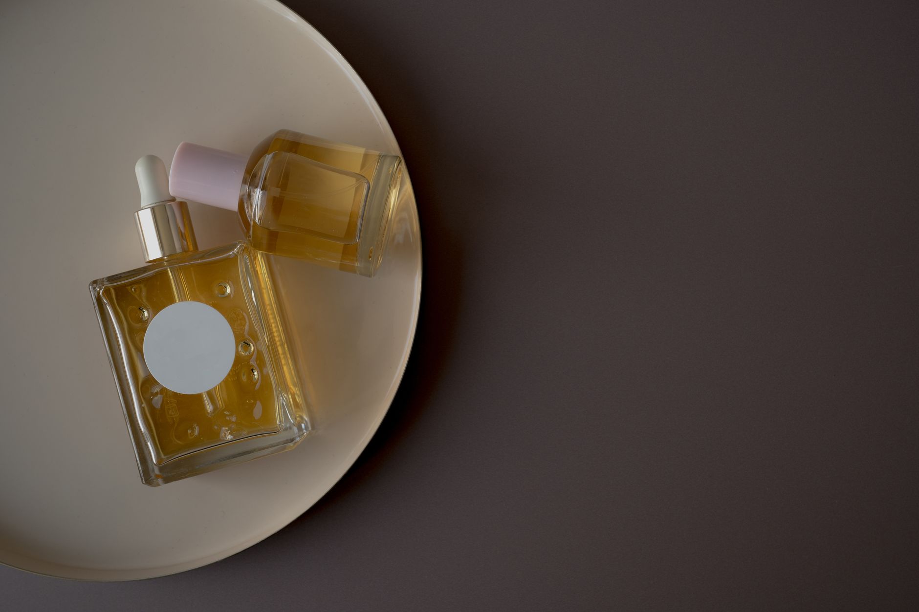 Minimalist composition of elegant perfume bottles on a stylish tray, perfect for beauty and fashion themes.