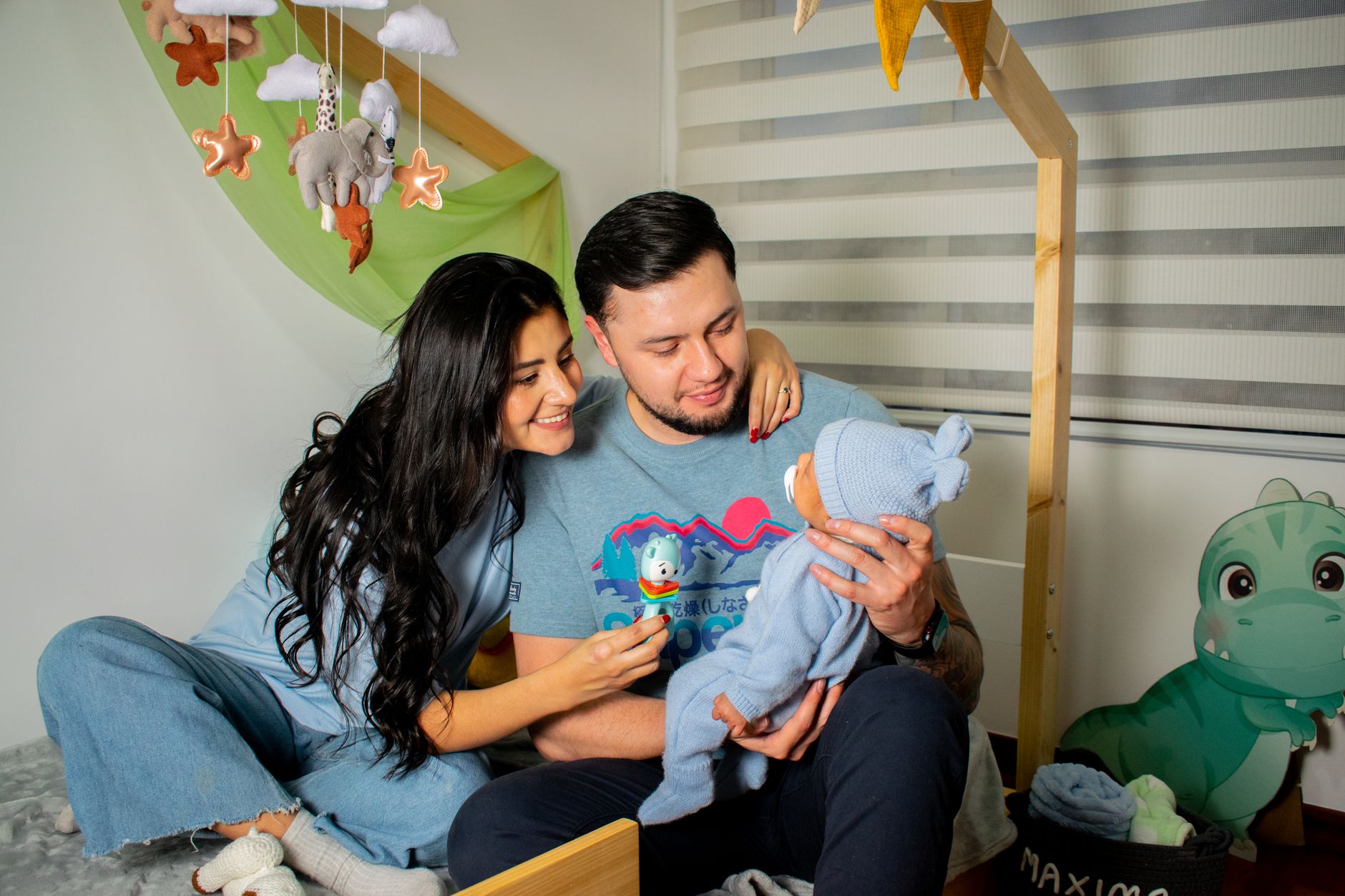 A happy family enjoys a cozy moment in the baby's nursery, filled with love and warmth.