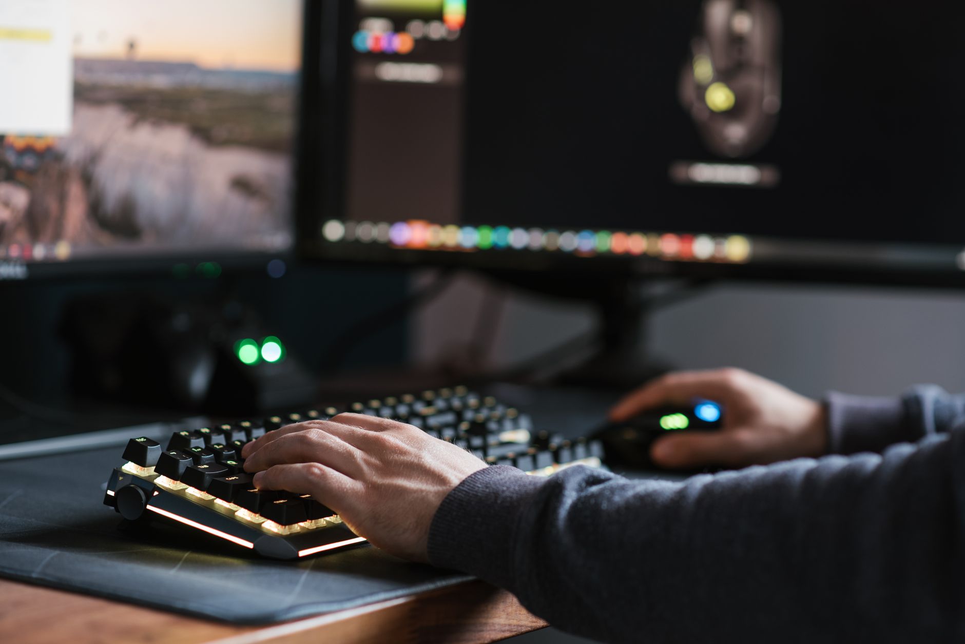 Crop anonymous male in casual outfit working on modern computer and typing on keyboard at home