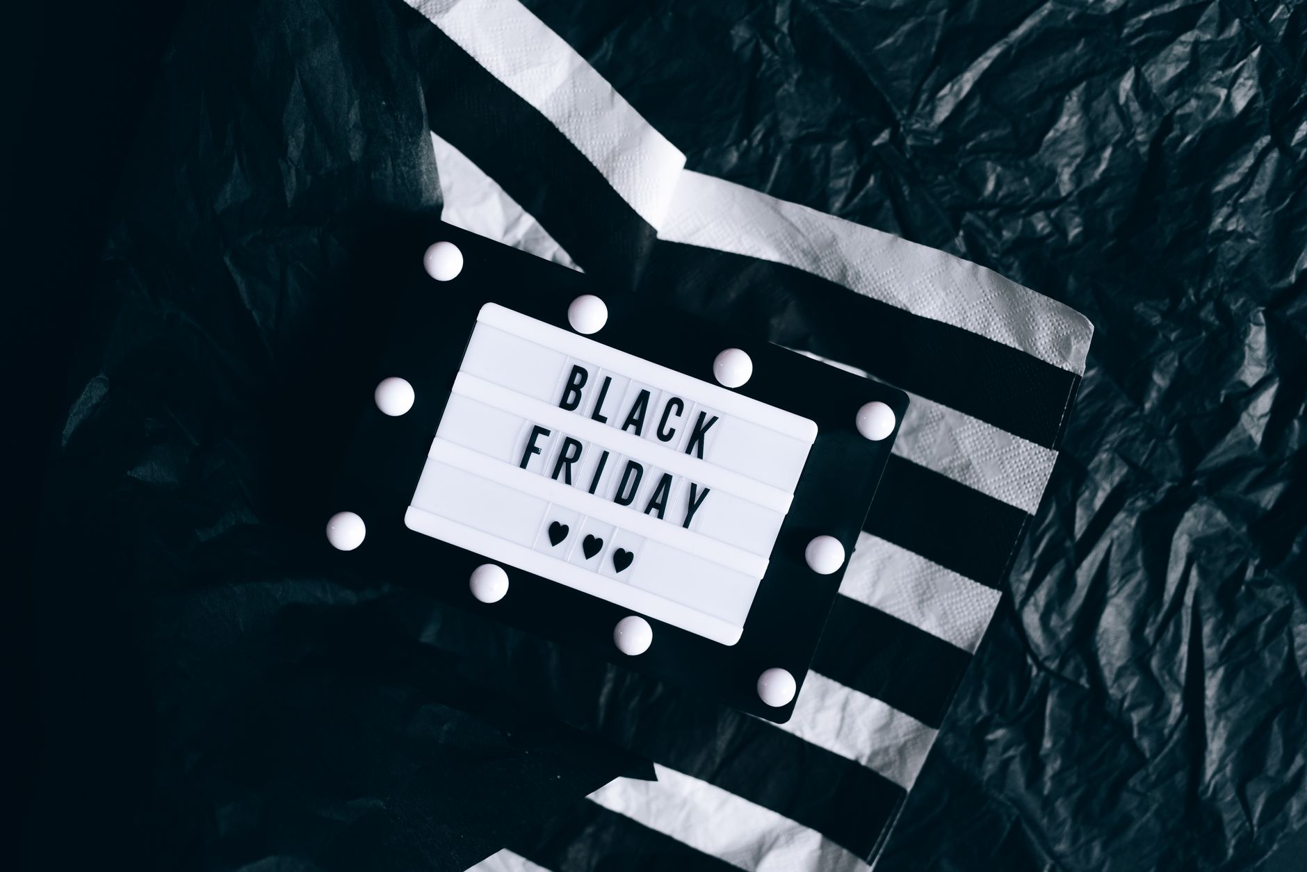 Minimalist Black Friday lightbox sign set against a stylish black and white background.
