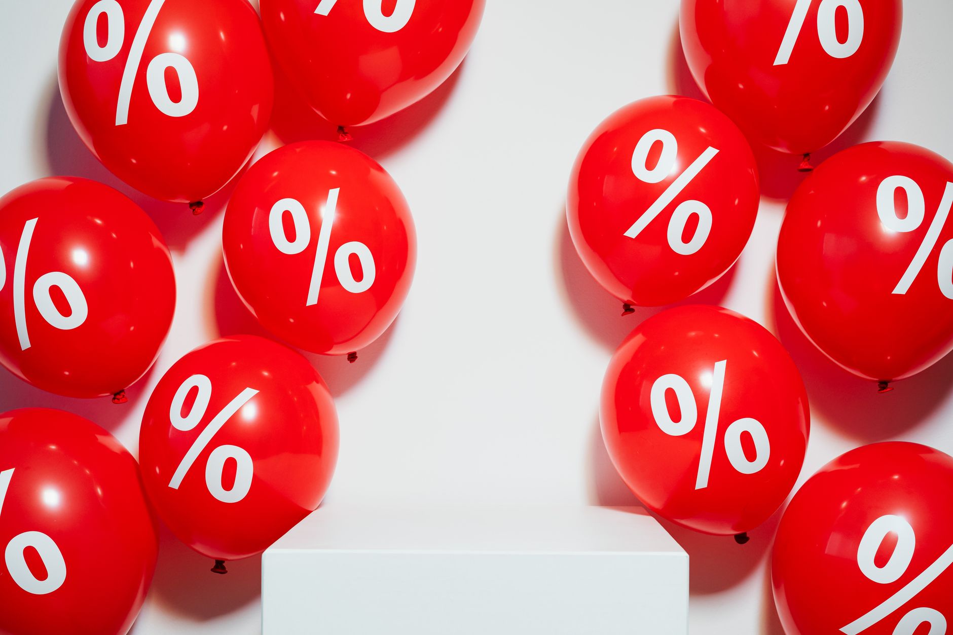 Red balloons with percentage signs, ideal for marketing promotions and sales events.