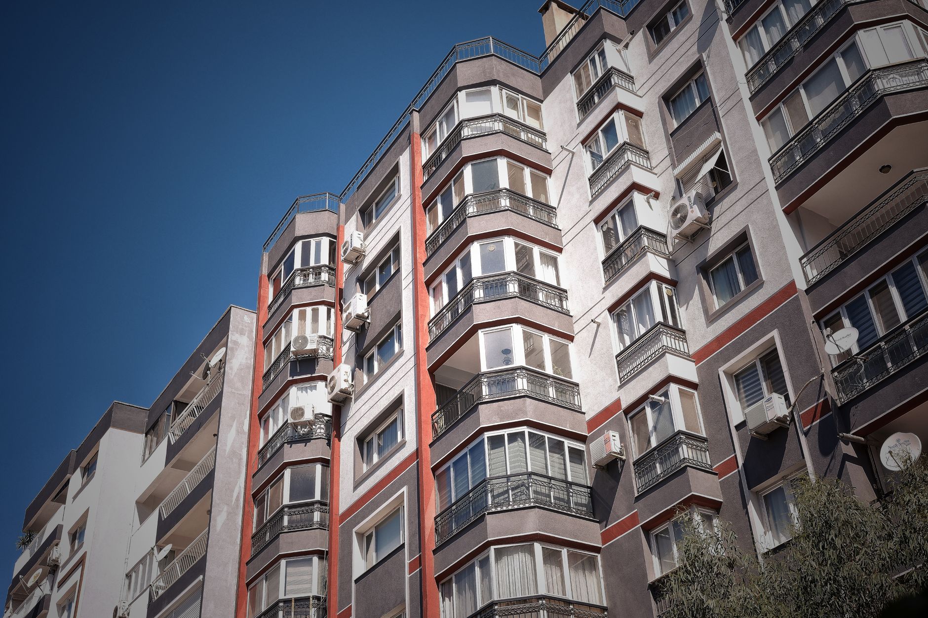 Low angle view of a modern apartment building in İzmir, Türkiye, highlighting urban architecture.