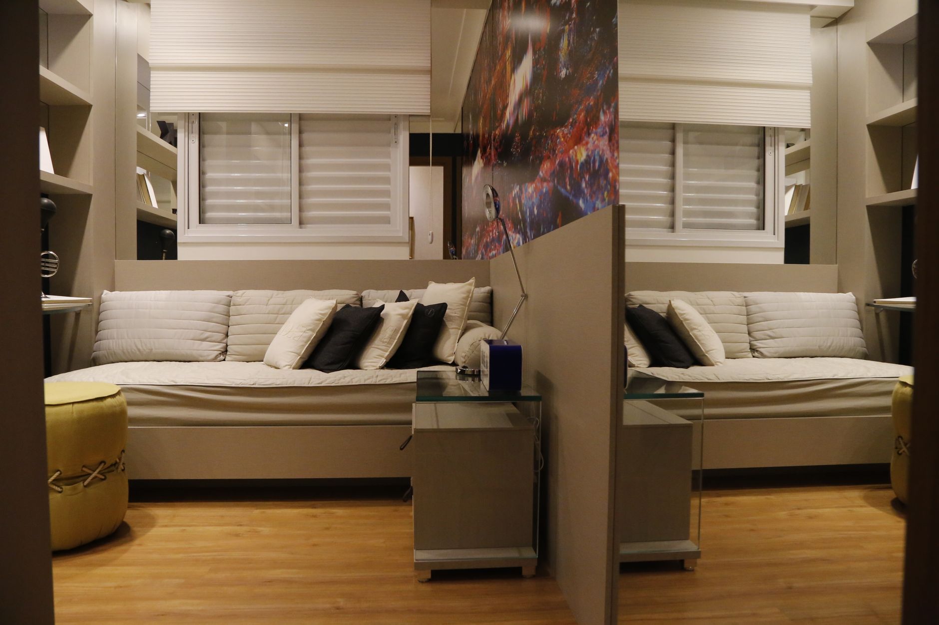 Stylish bedroom interior featuring cozy furniture and mirror reflection.