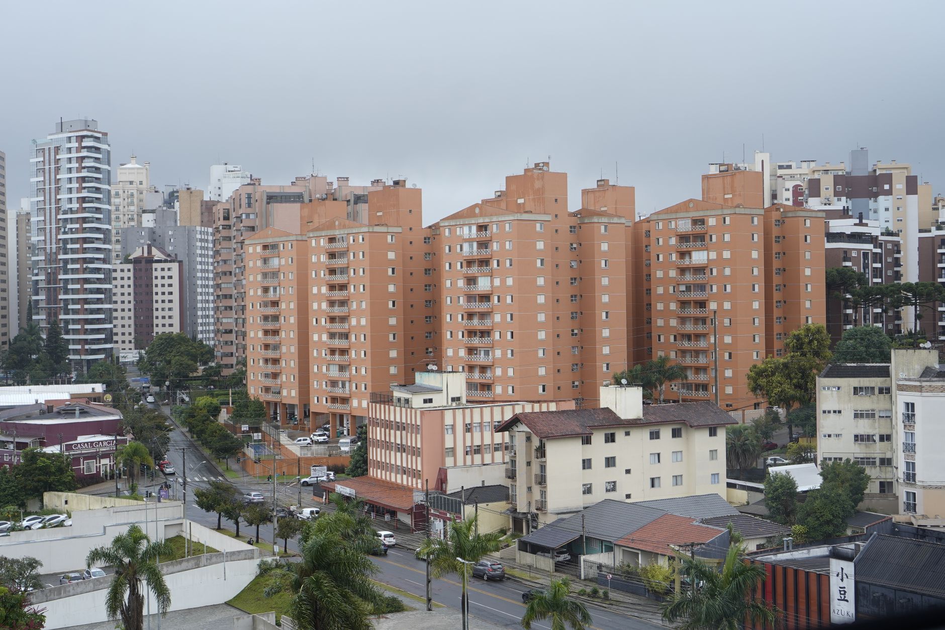 Urban landscape with high-rise apartments under a gloomy sky, showing modern city living.