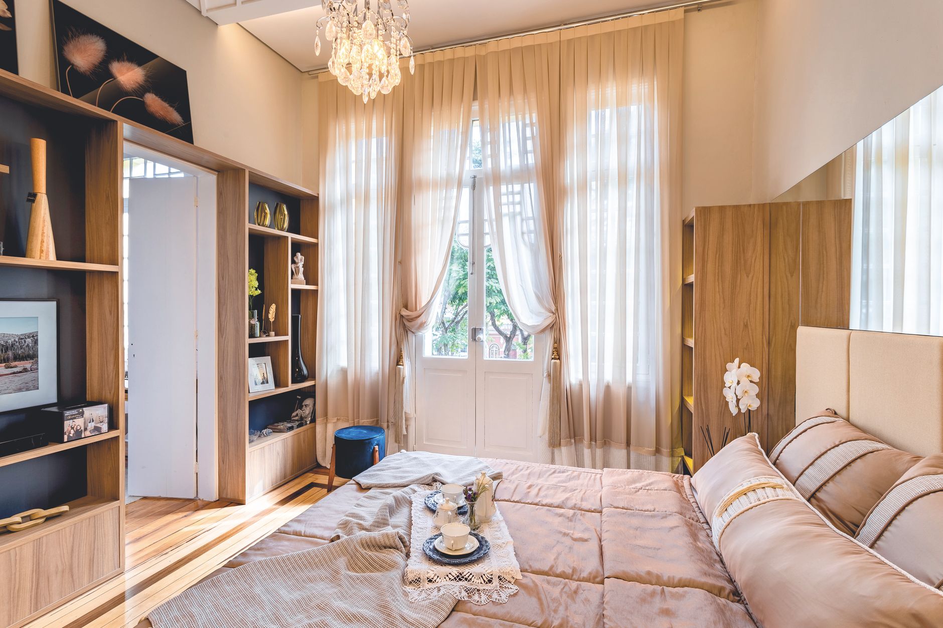 An inviting bedroom featuring elegant decor, soft lighting, and a cozy atmosphere, perfect for relaxation.