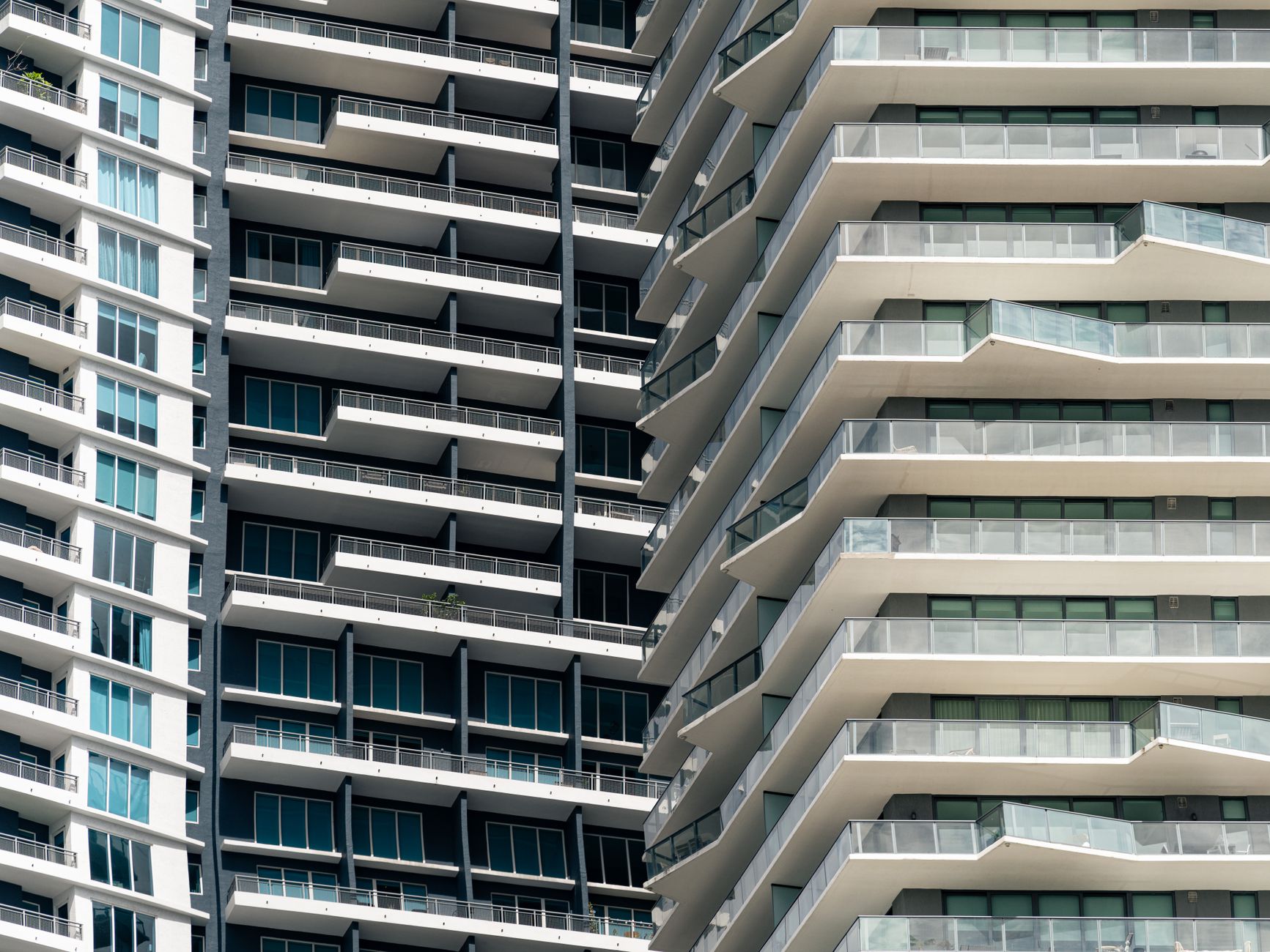 Close-up view of contemporary skyscrapers in Miami, showcasing geometric balconies and urban design.