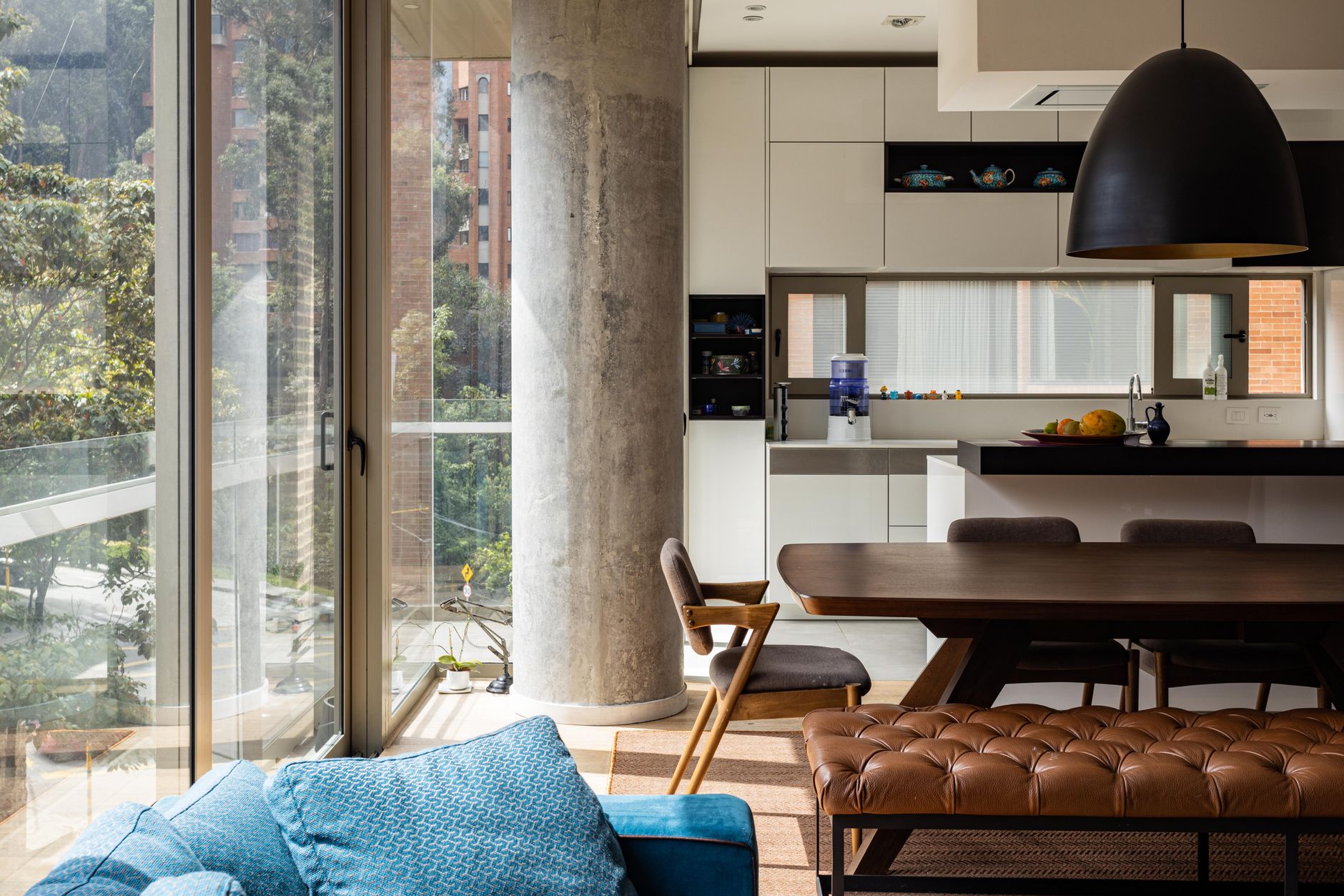 Spacious modern apartment in Bogotá featuring a stylish kitchen and living area with abundant natural light.
