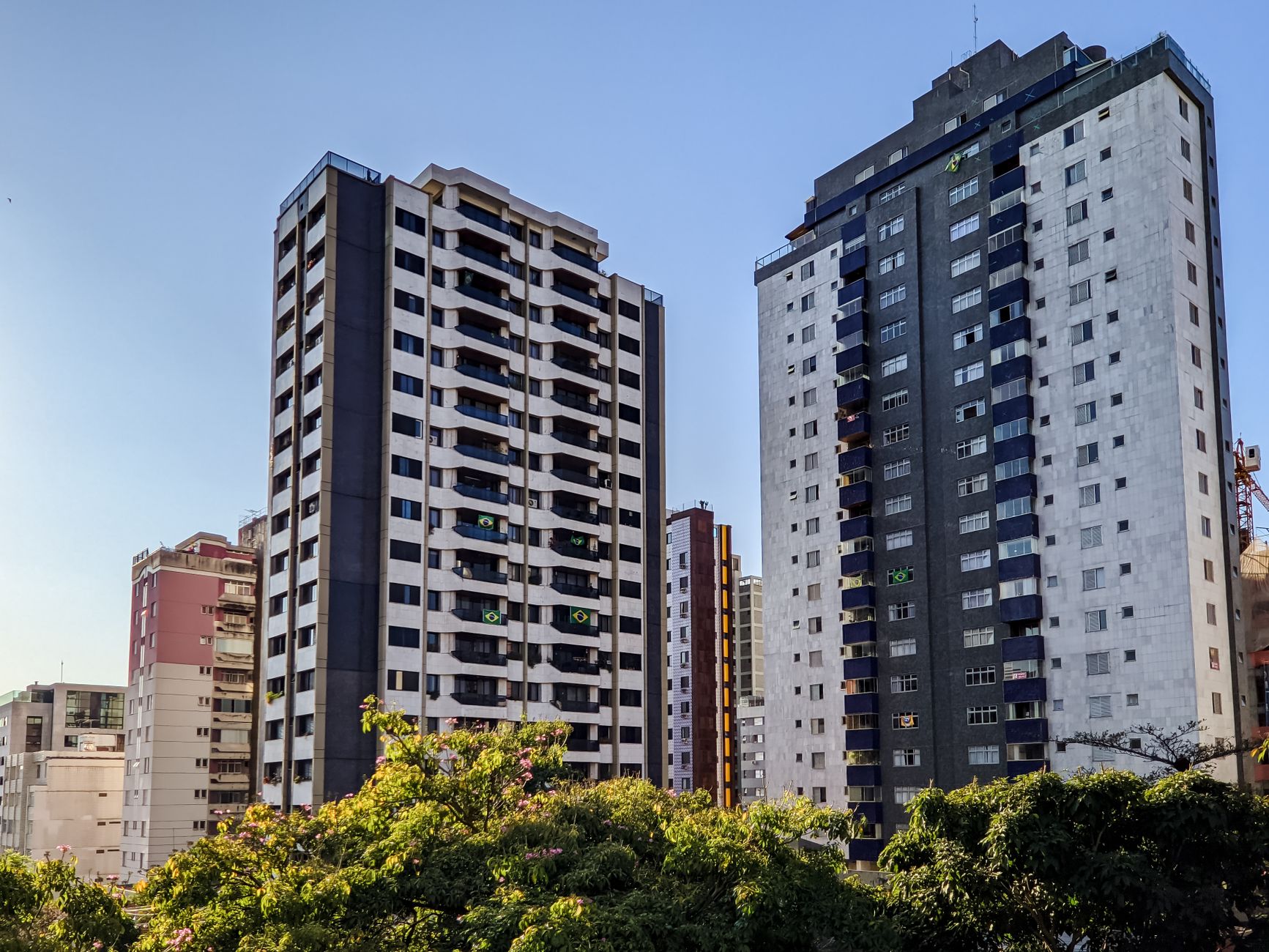 High-rise urban cityscape featuring modern apartment buildings and greenery.