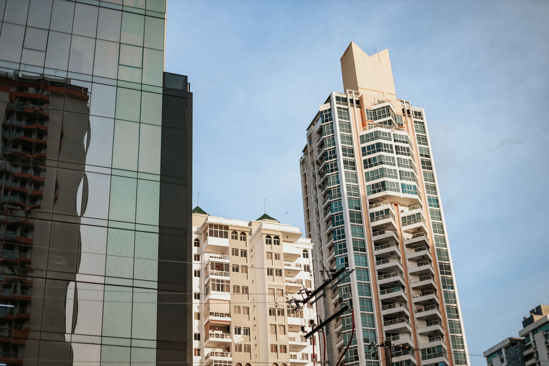 Urban cityscape featuring modern skyscrapers under a clear sky, showcasing contemporary architecture.
