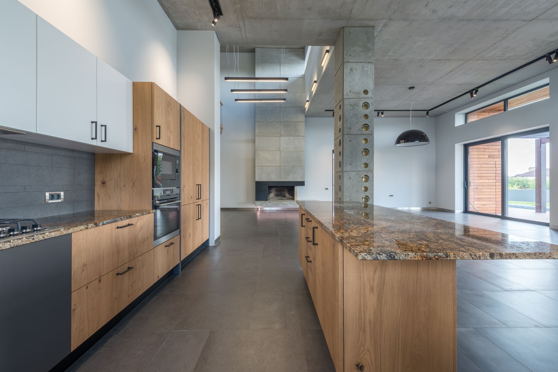 Empty light apartment with kitchen furniture and wooden table in lobby near exit