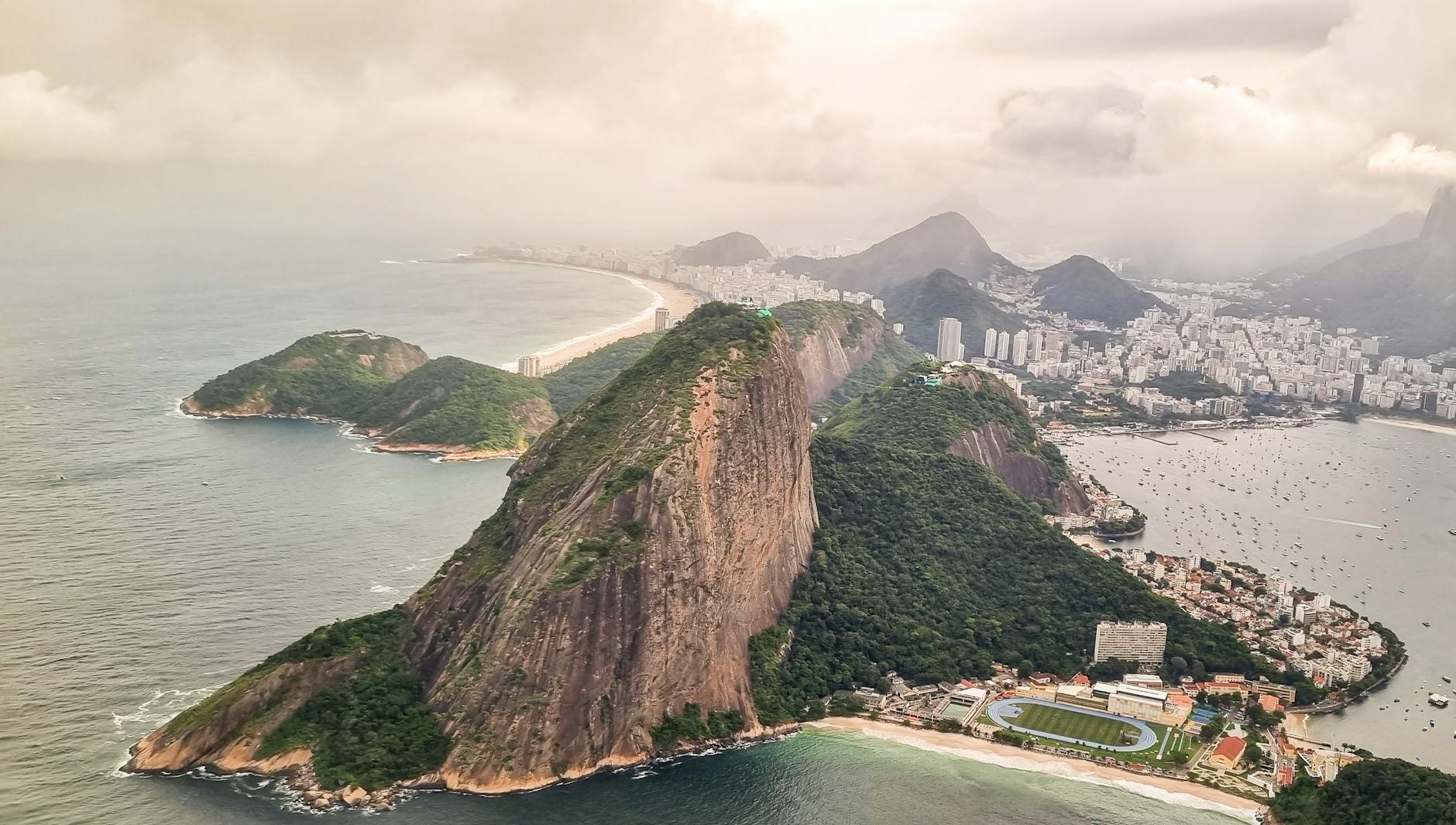Stunning aerial view of Sugarloaf Mountain and Rio de Janeiro's vibrant coastline.