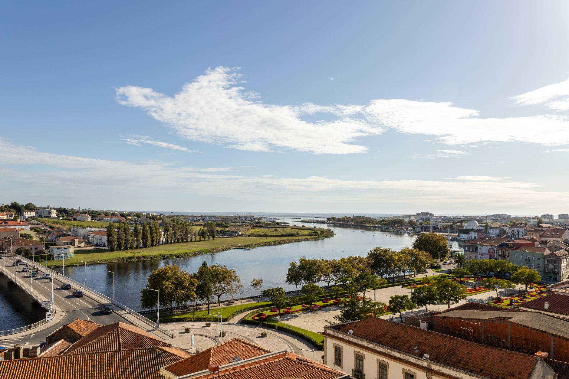Aerial view of the serene river in Vila do Conde, Porto, showcasing picturesque architecture and lush greenery.