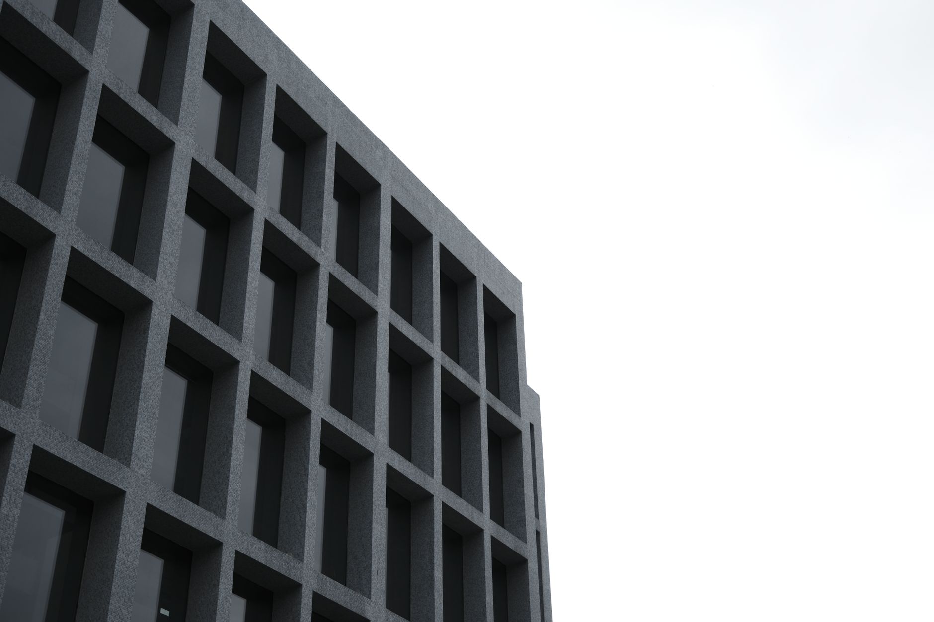 Low angle view of a modern building's facade with grid pattern windows in Istanbul.
