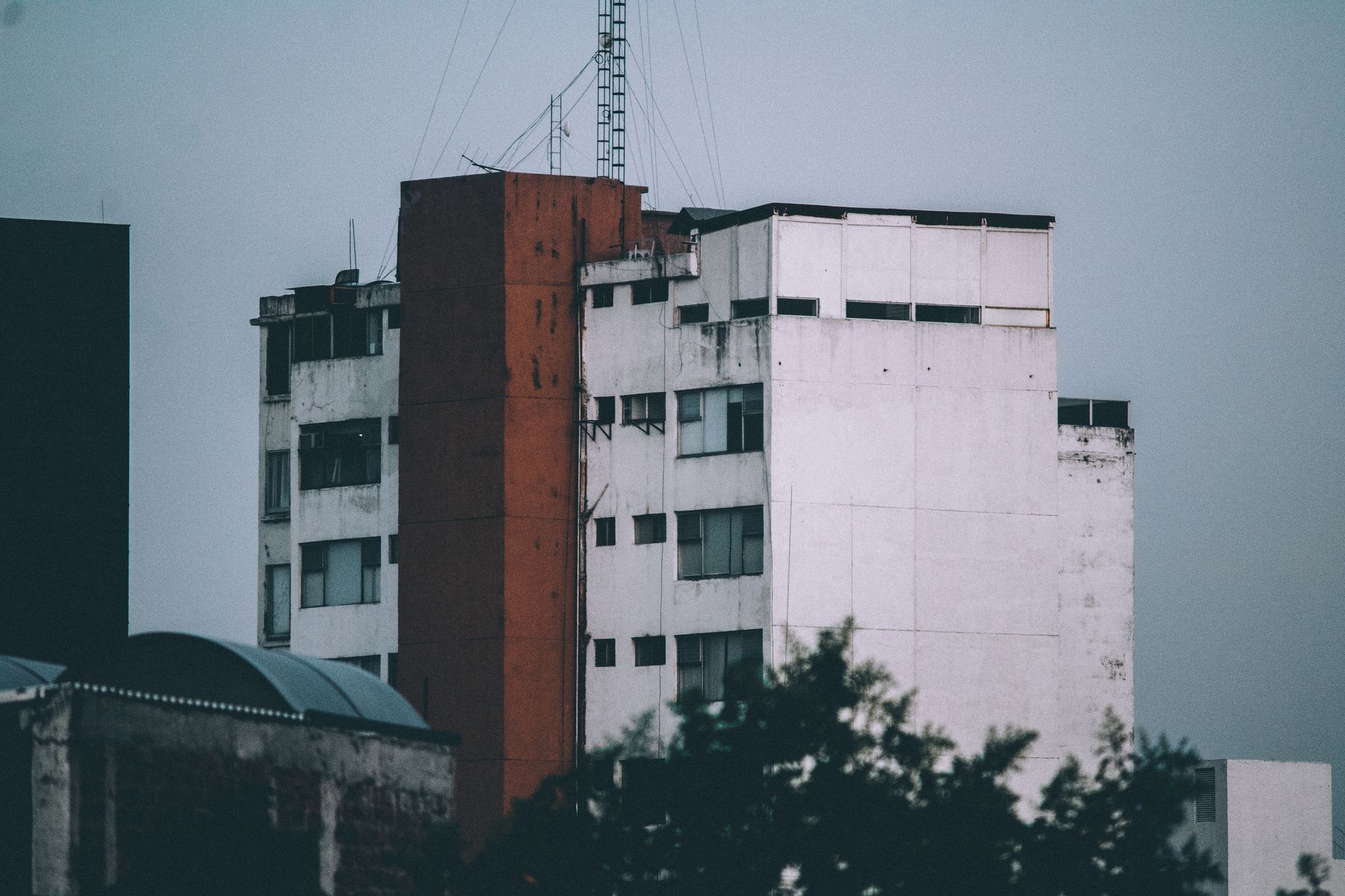 A modern urban building with textured facade captured in daylight, under an overcast sky.