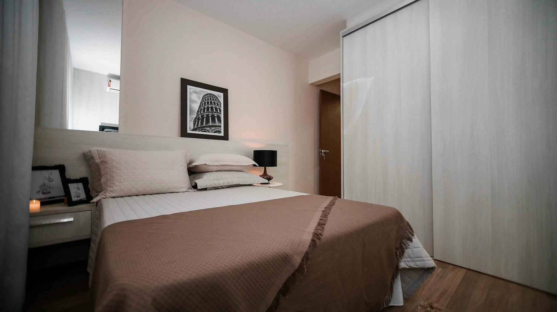 A serene modern bedroom interior featuring minimalist design elements and cozy aesthetics.