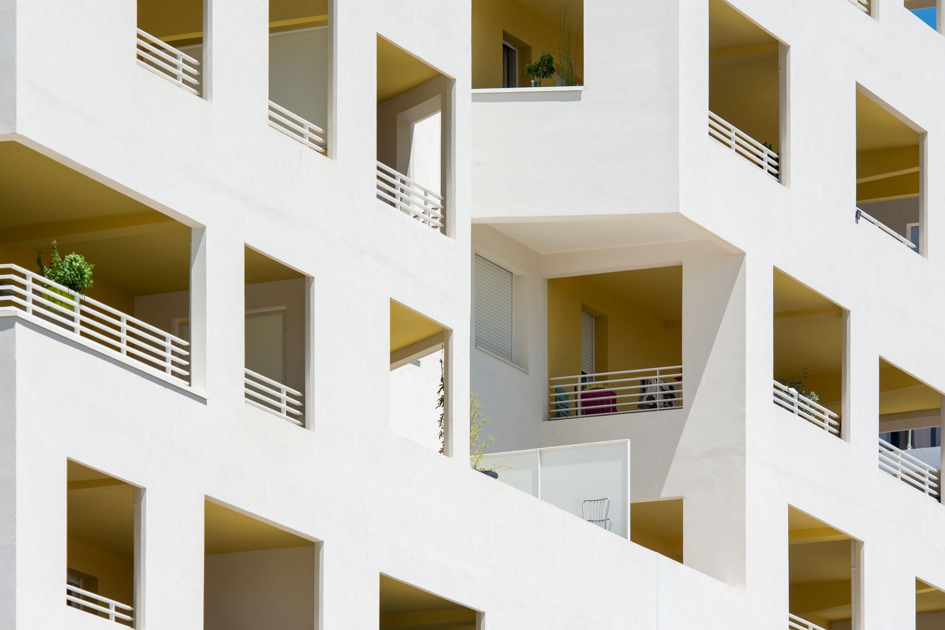 Close-up of modern apartment facades in Montpellier, showcasing geometric design and open spaces.