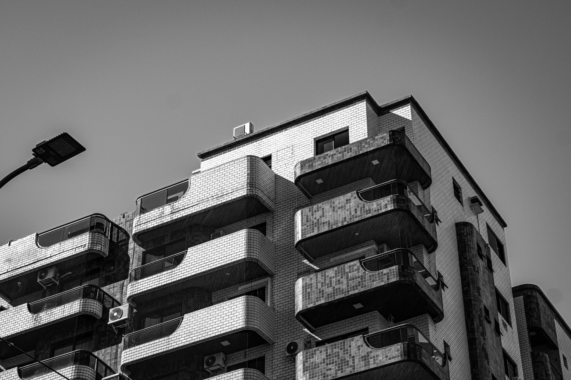 Striking black and white photo of a modern urban apartment building showcasing unique architectural design.