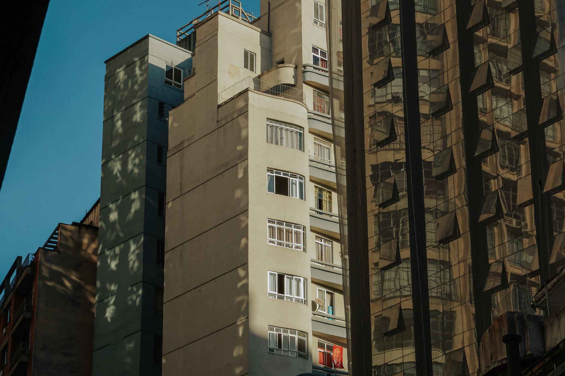 Modern urban architecture reflecting in glass surfaces in downtown Curitiba, Brazil.