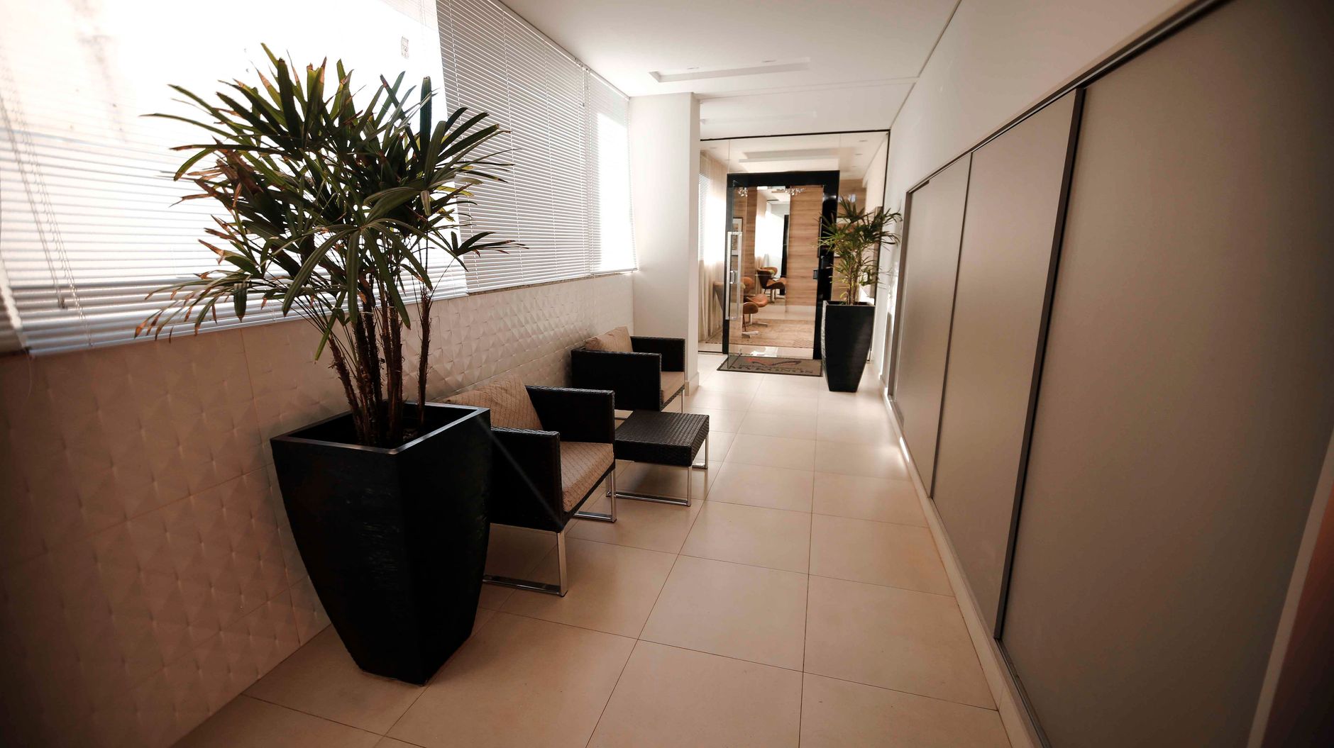 Contemporary hallway featuring sleek design, indoor plants, and stylish seating arrangements.