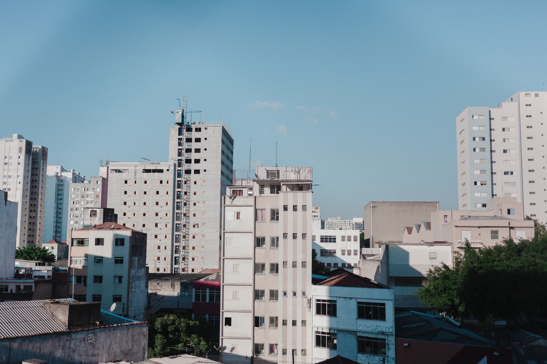 Contemporary cityscape featuring modern apartment buildings under a clear blue sky.