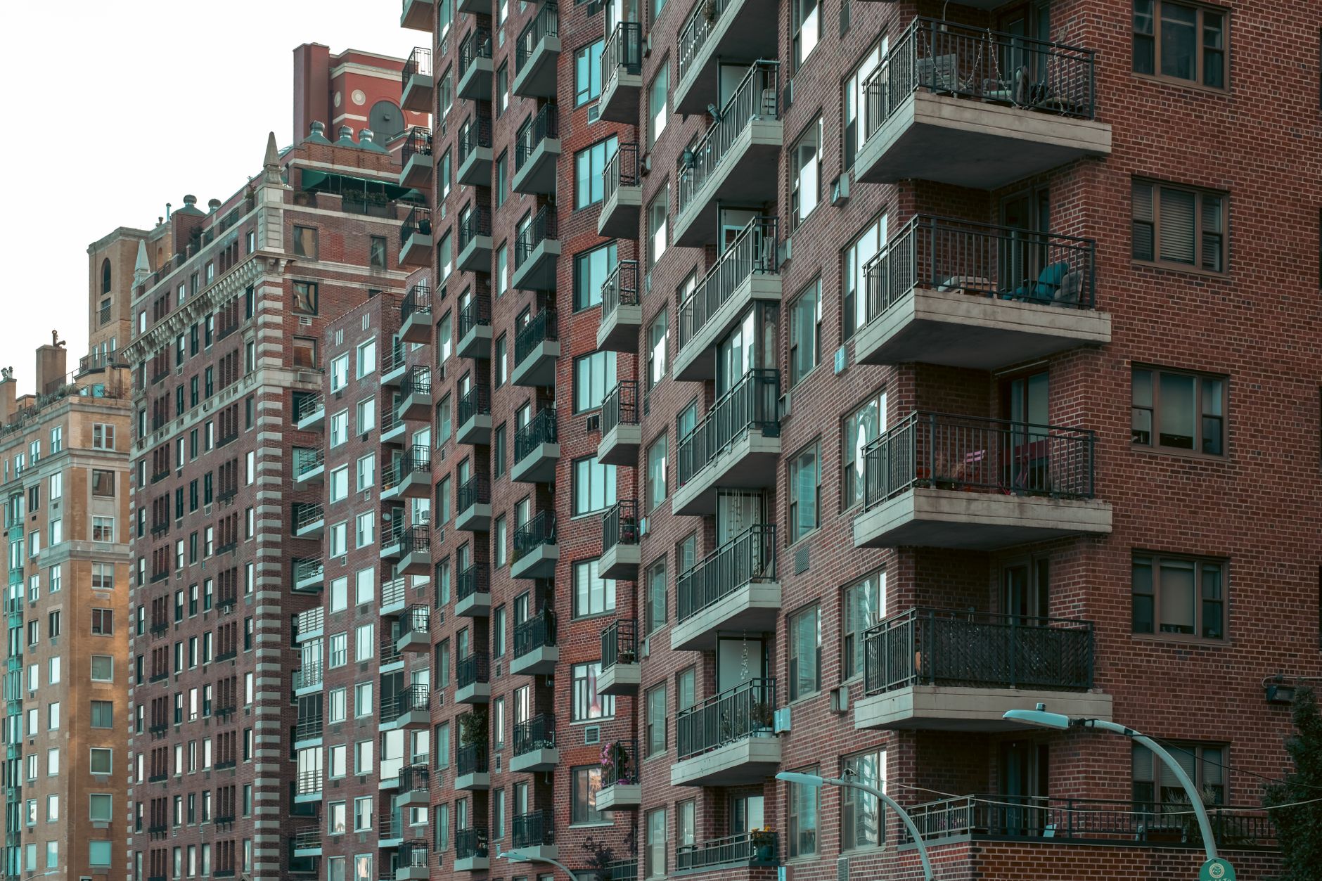 A view of urban New York City apartment buildings with balconies.