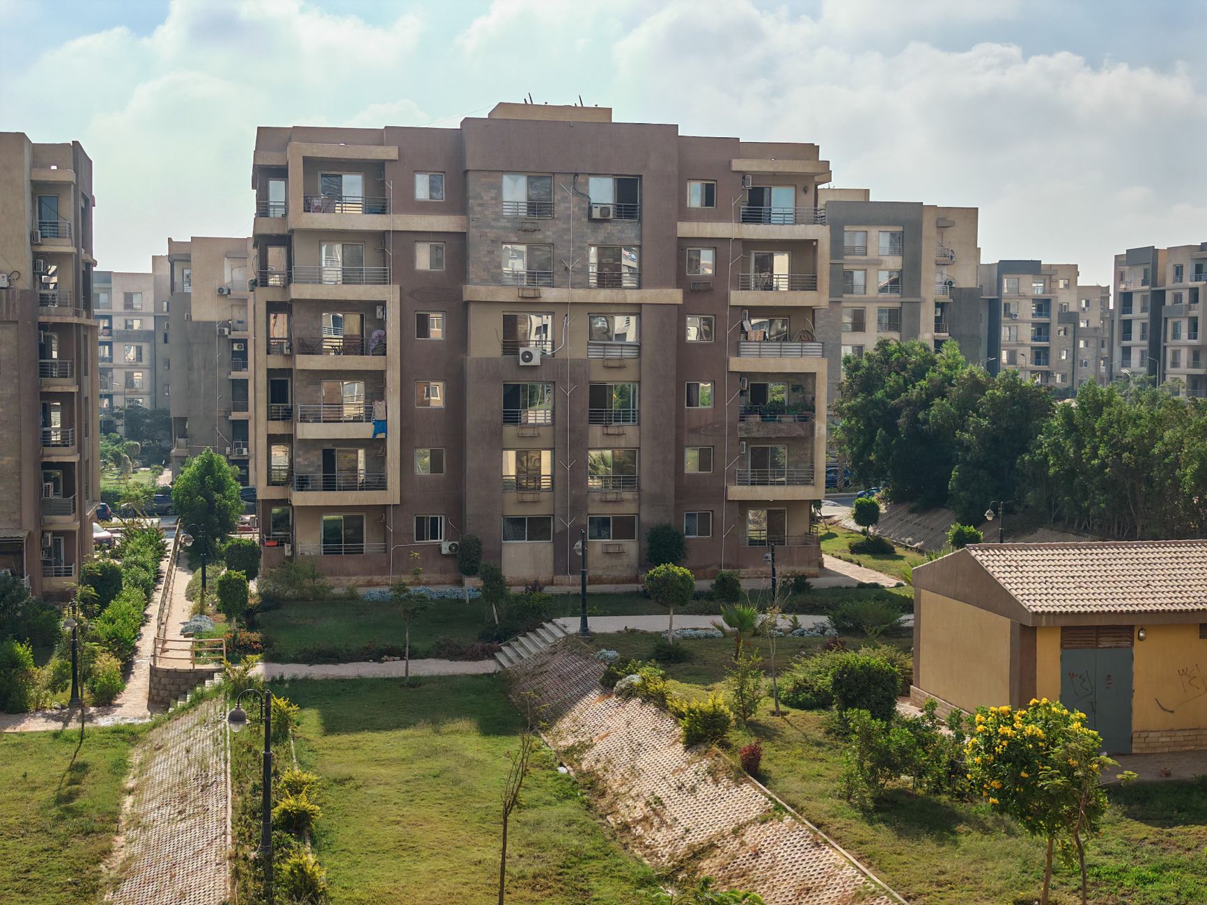 Aerial view of residential apartment buildings surrounded by greenery.