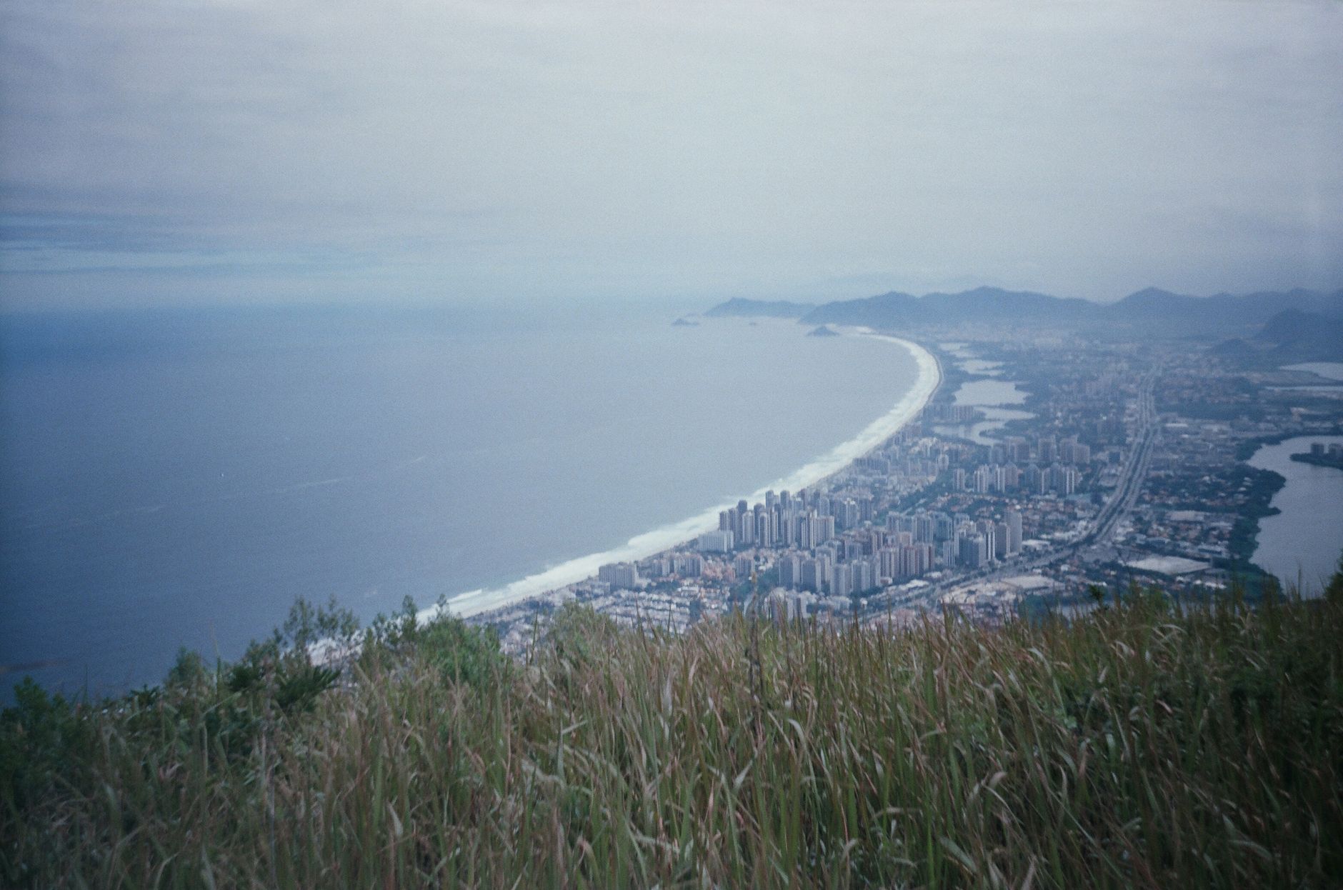 Aerial view of Rio de Janeiro's expansive coastline with the cityscape against the ocean.