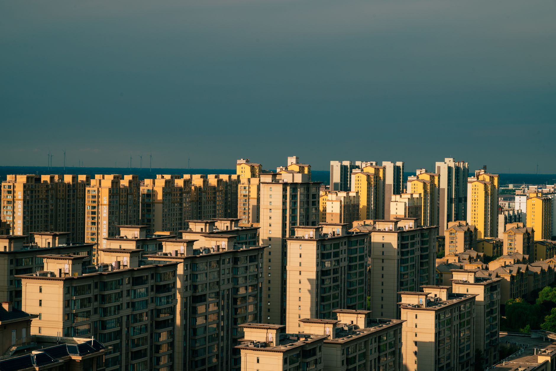 Bright cityscape view of modern high-rise apartments with a clear sky backdrop.