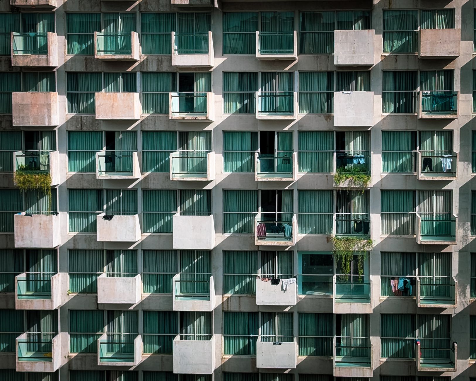 Symmetrical view of apartment balconies in Cox's Bazar, Bangladesh, showcasing geometric patterns and modern architecture.