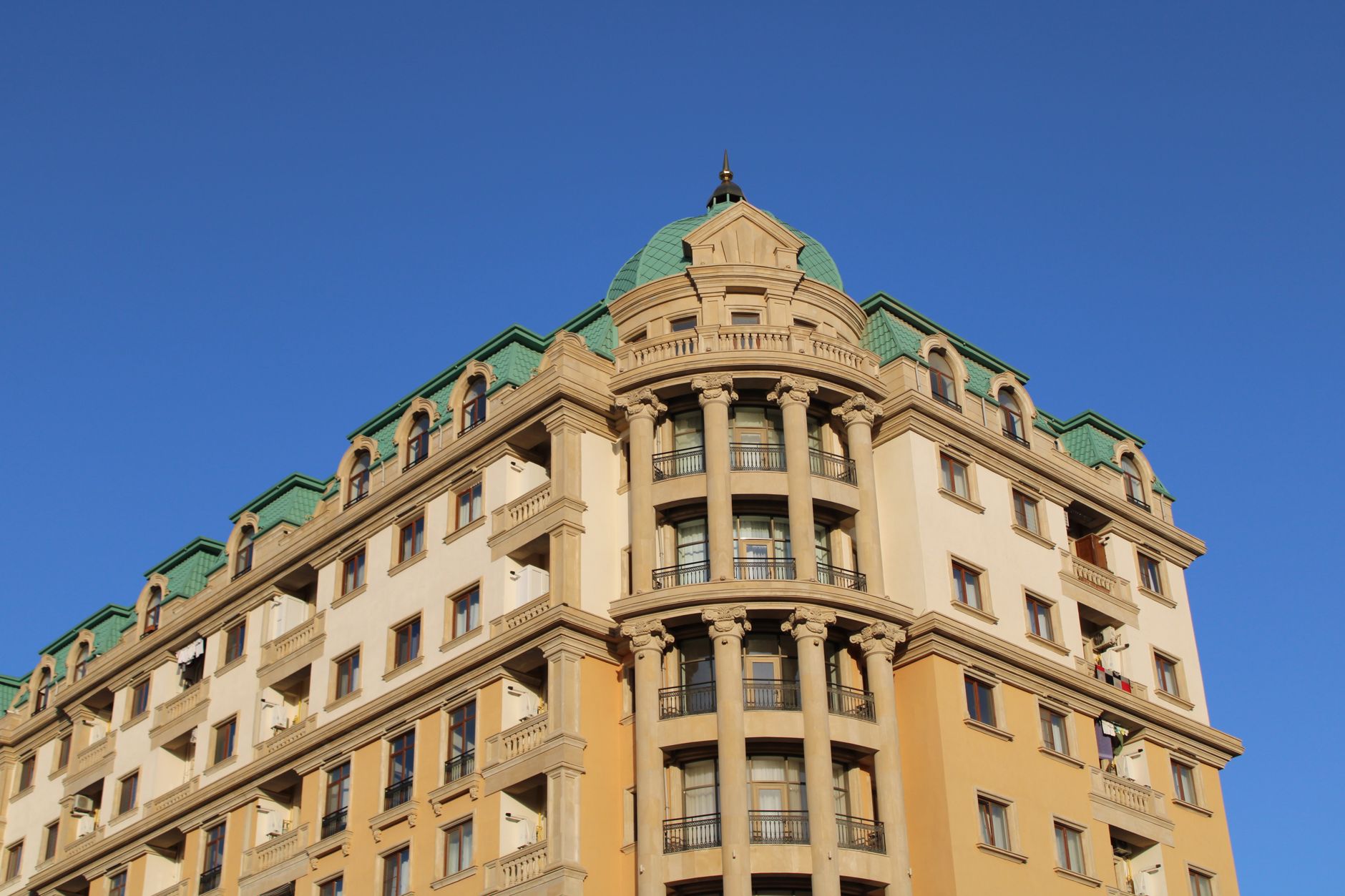 Low-angle view of a classical architecture building with a blue sky background.