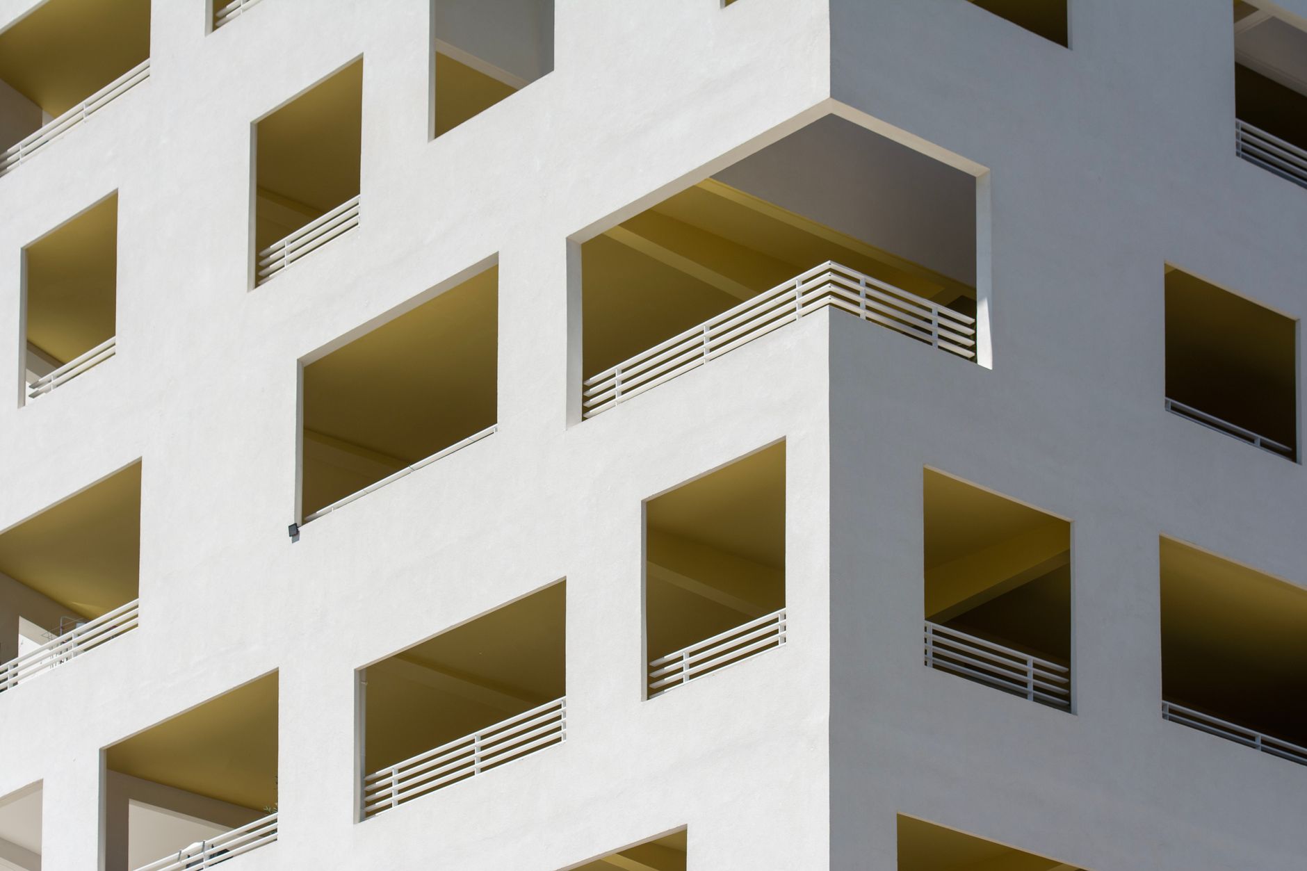 Close-up of a contemporary residential building facade with geometric balconies.