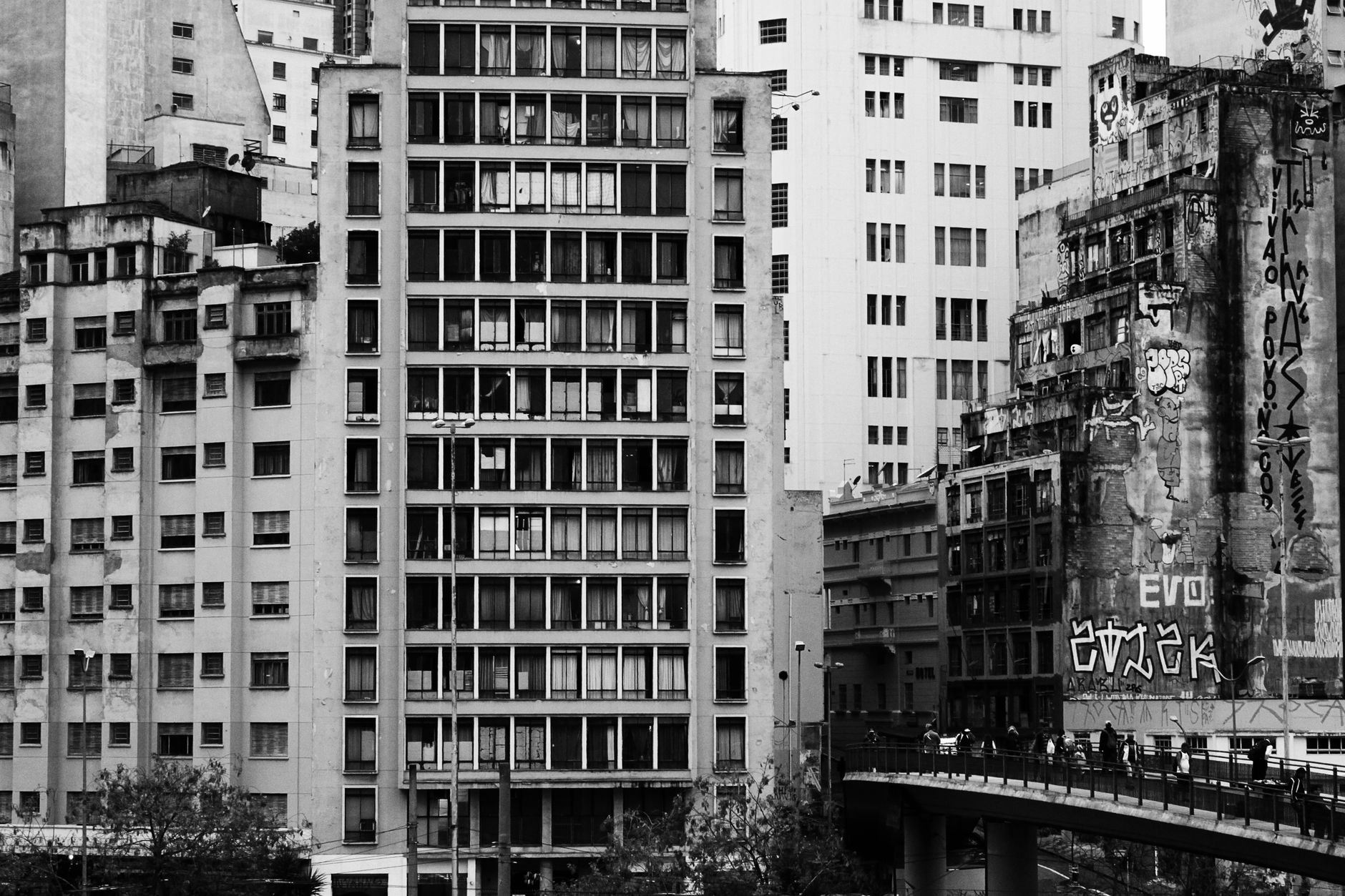 Monochrome cityscape of high-rise buildings and graffiti in São Paulo.