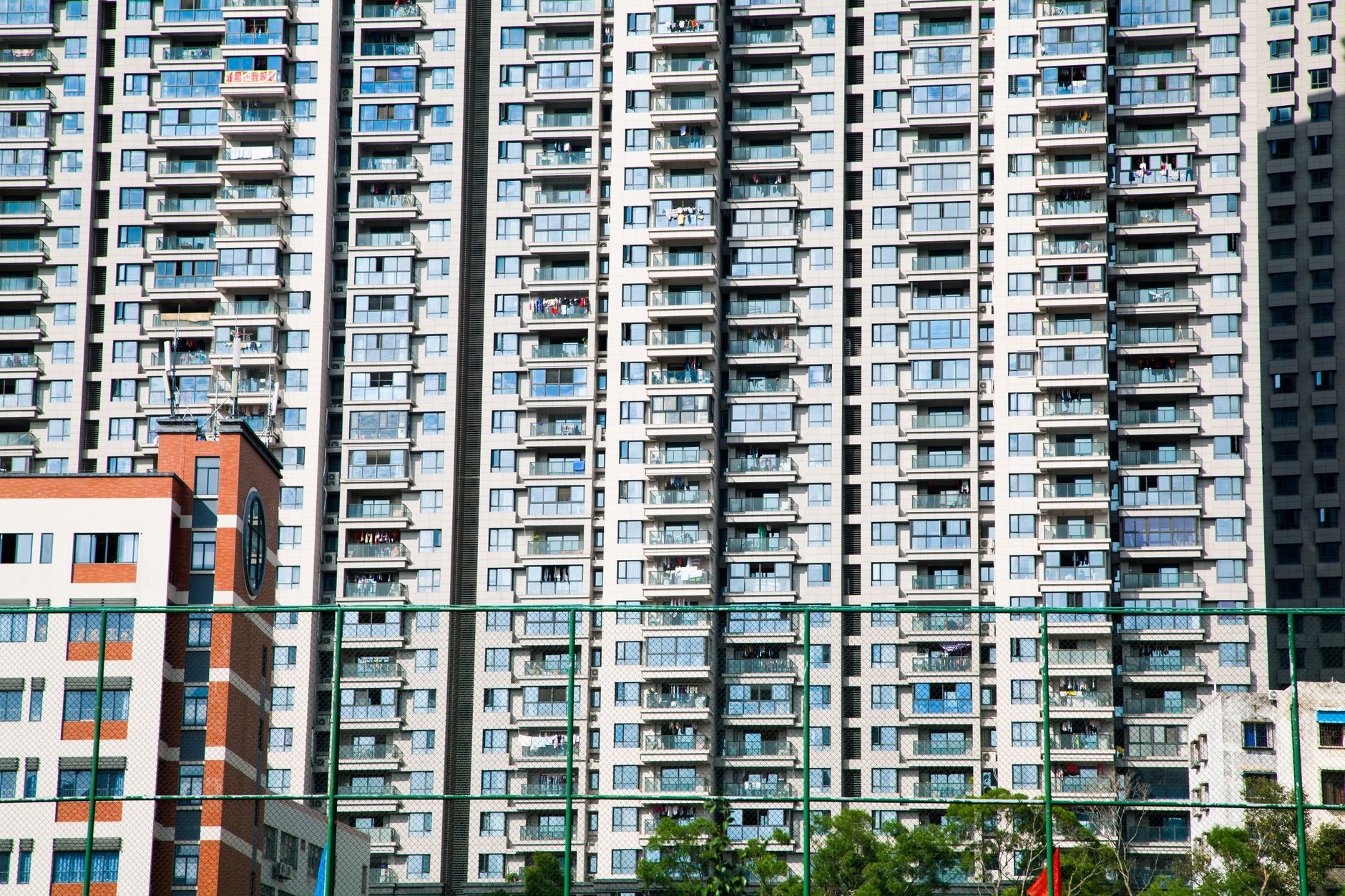 Low angle shot of a tall modern skyscraper in an urban cityscape. Ideal for business and architecture themes.