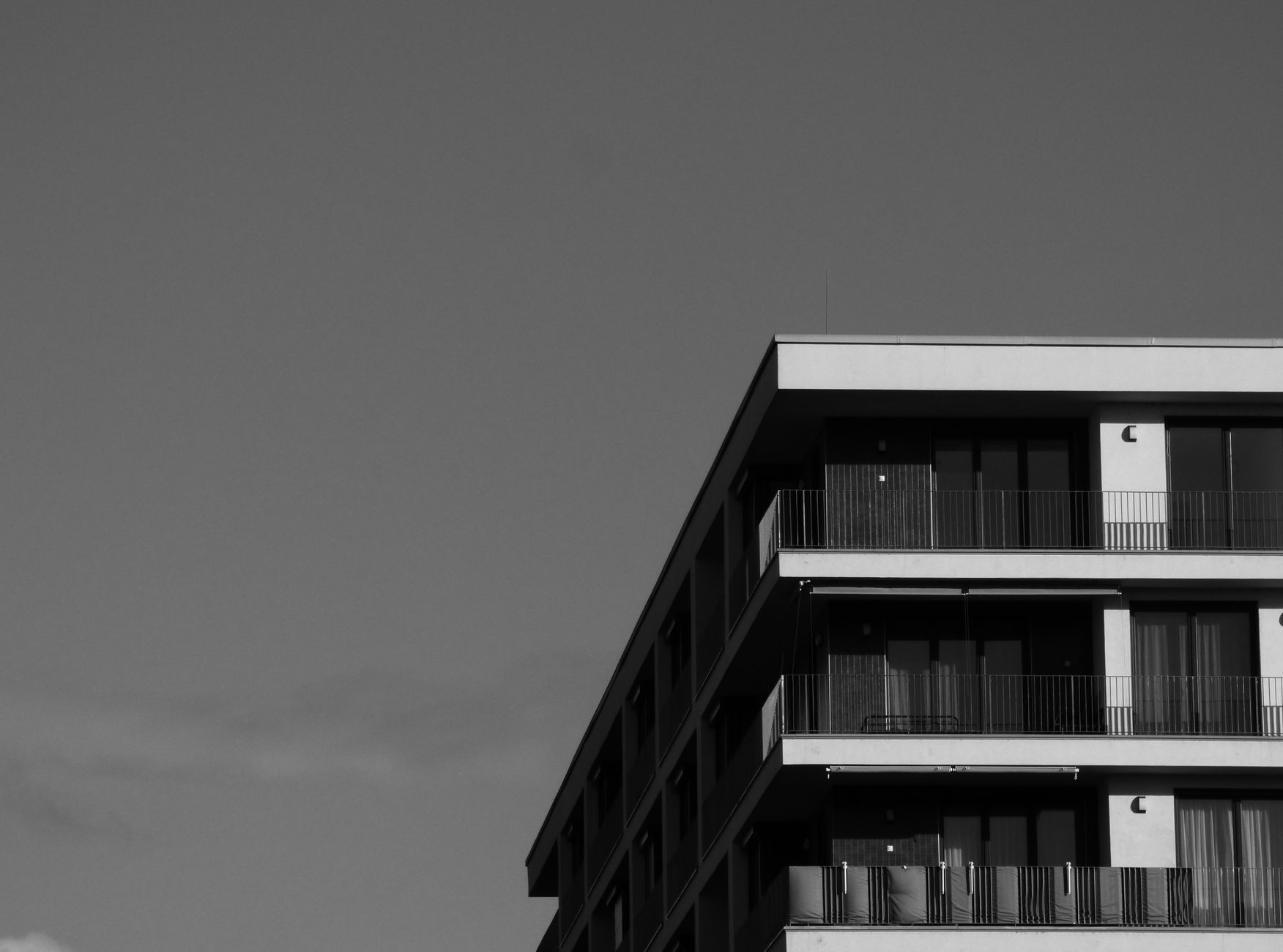 Black and white photo of a modern residential building with ample copy space.
