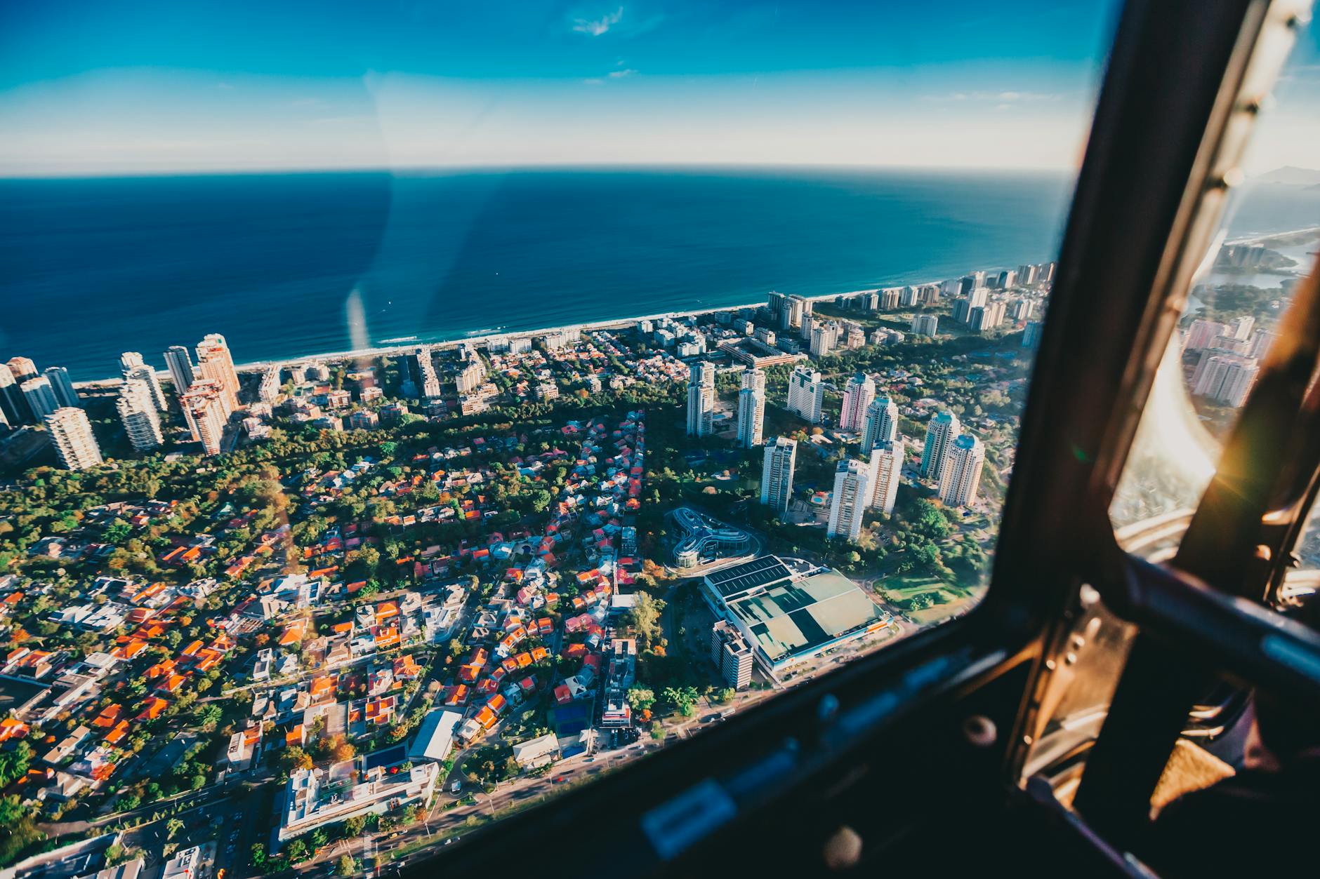 Scenic aerial view of Rio de Janeiro's urban landscape and coastline from a helicopter.
