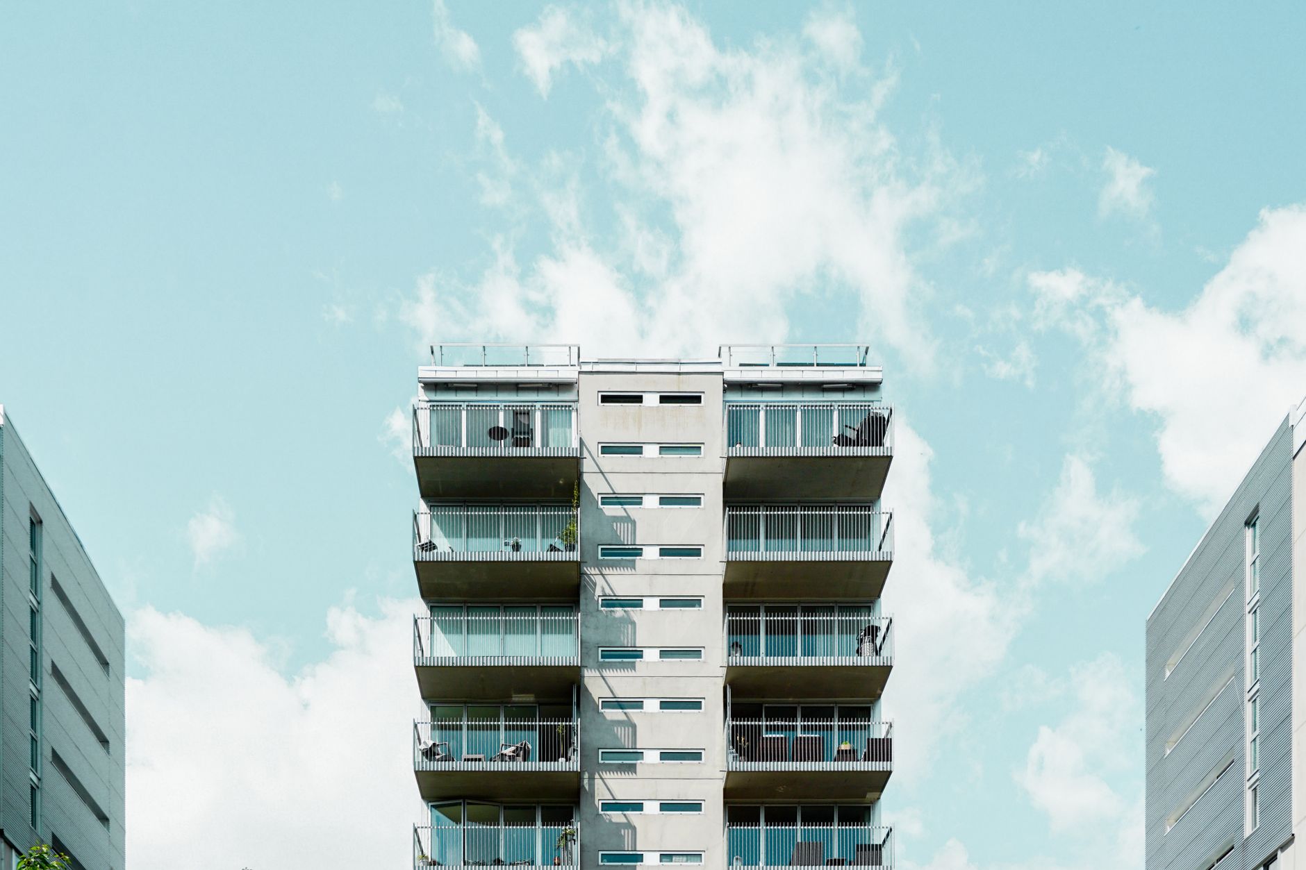 Contemporary residential building with balconies against a clear sky in Oslo, Norway.