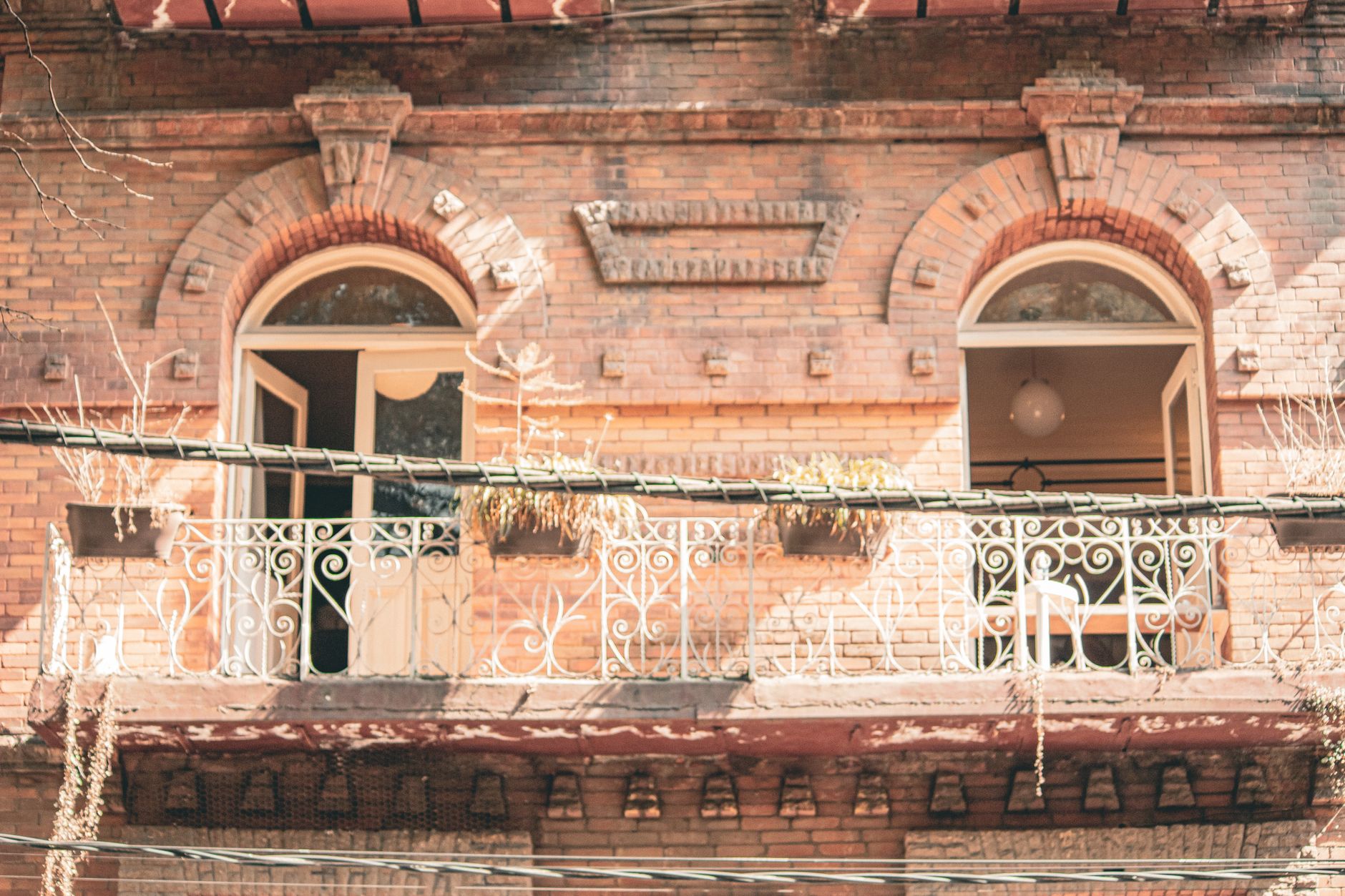 Vintage-style balcony on a brick building in Mexico City, capturing classic architecture.