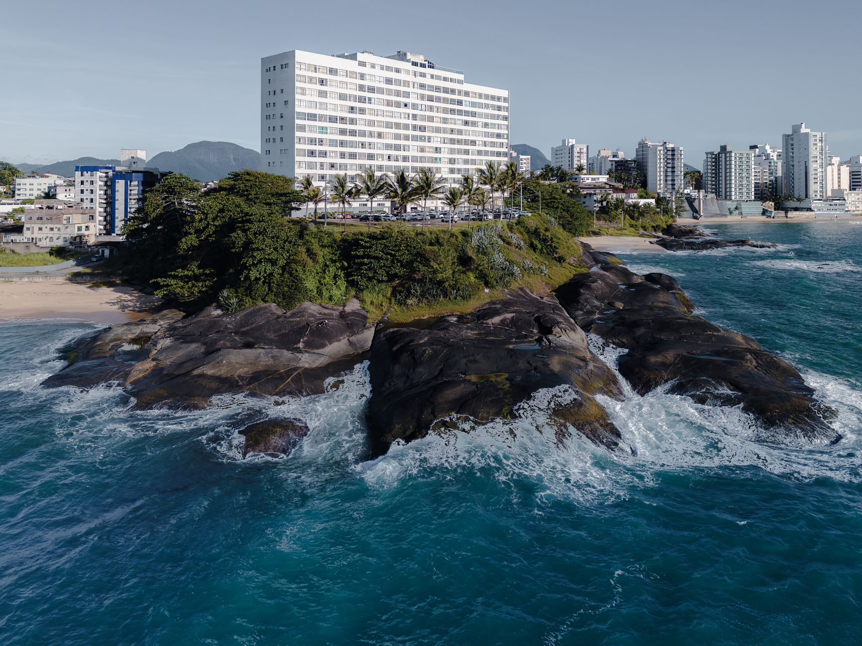 Aerial photograph showcasing the coastline and urban landscape of Guarapari, Brazil.