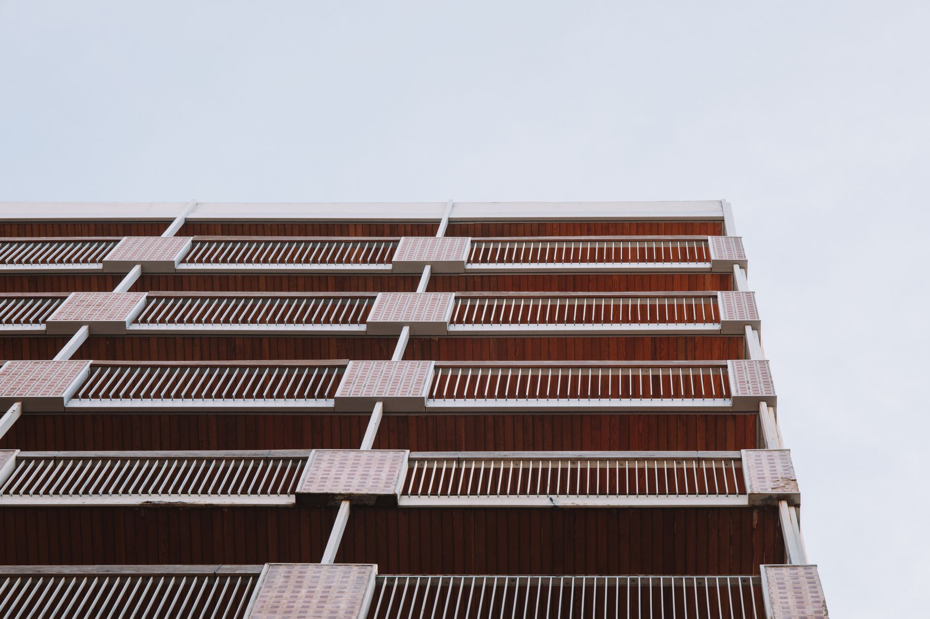 A modern residential building with balconies in Valencia, Spain, captured from a low angle.