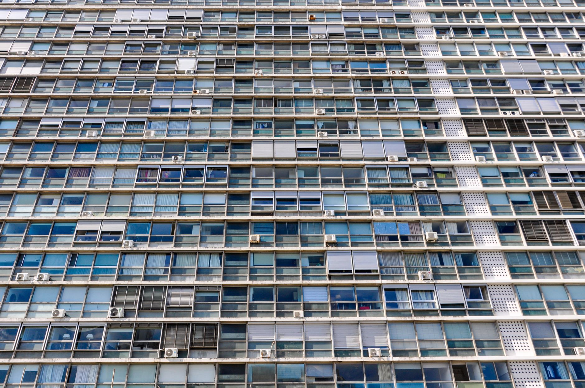 High-rise apartment building with glass windows in Montevideo, Uruguay highlighting urban architecture.