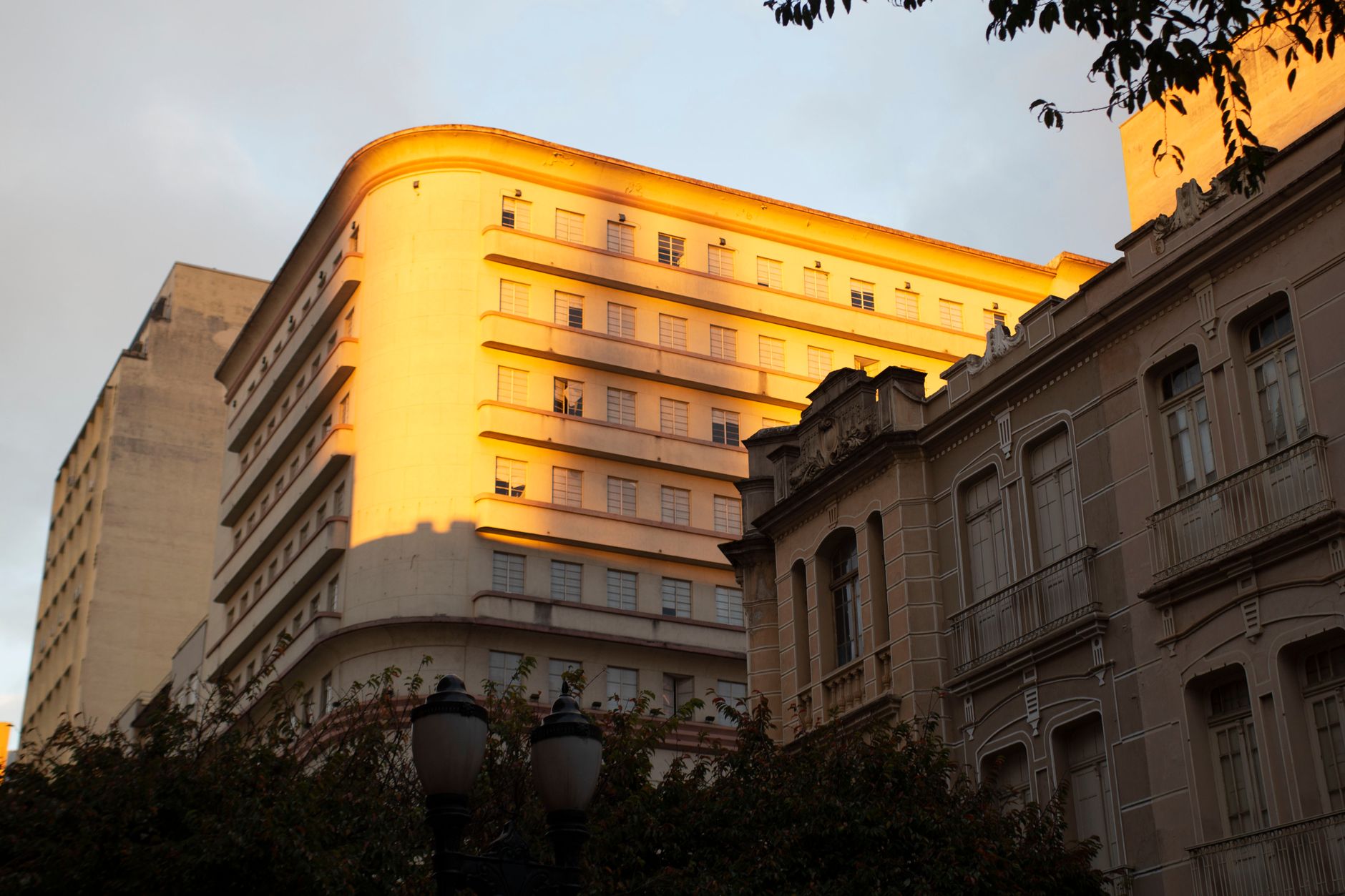 Gorgeous view of sunlit colonial buildings in Curitiba's historic center at sunset.