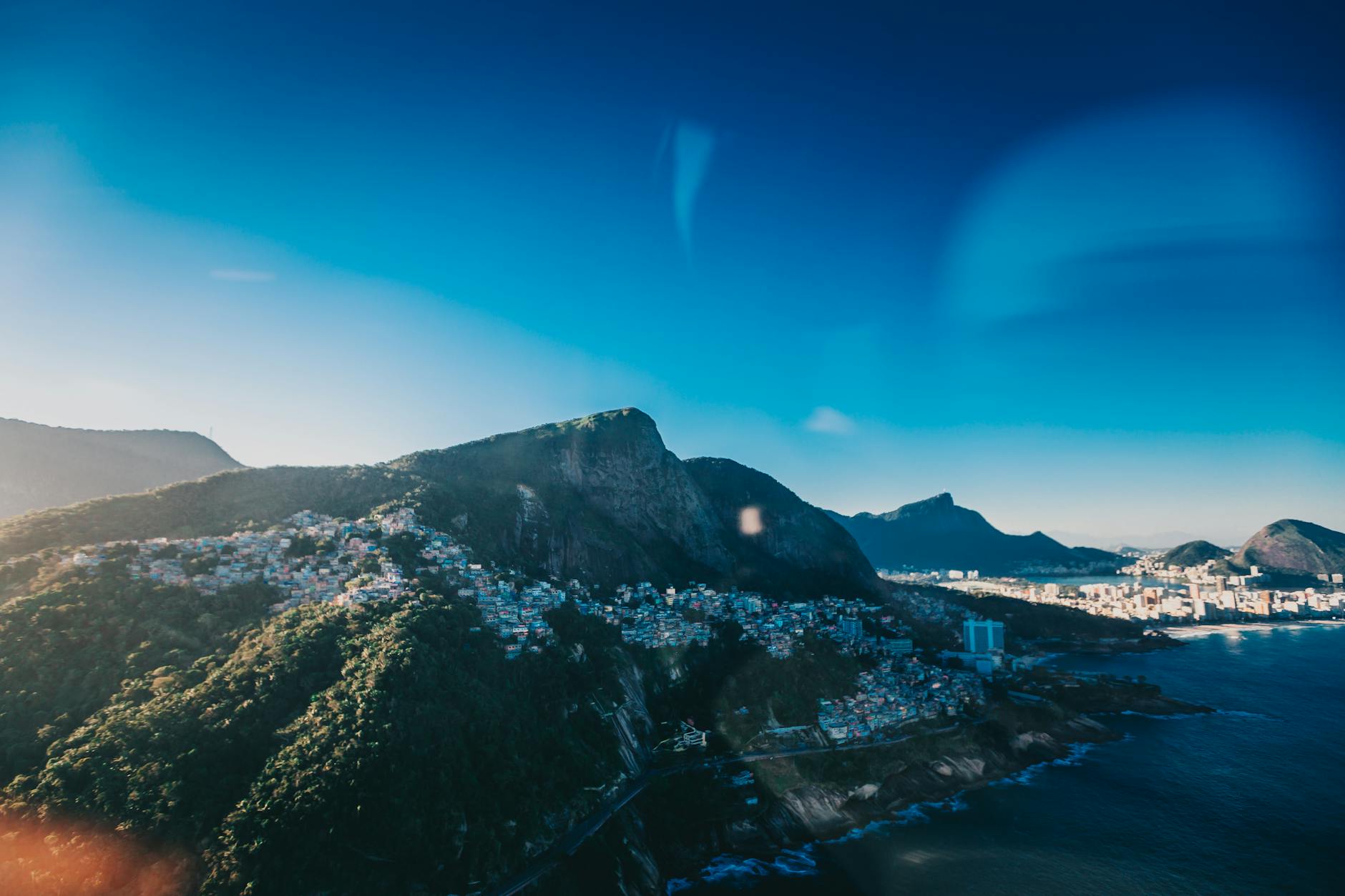Breathtaking aerial view of Rio de Janeiro's coastline, featuring mountains and the ocean.