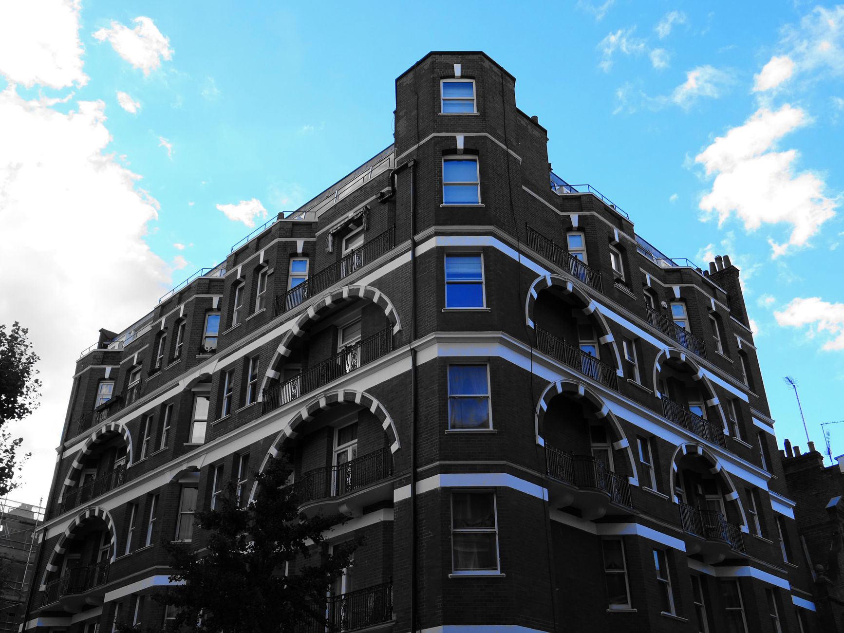 A modern building with prominent arches under a clear blue sky, capturing urban architecture.