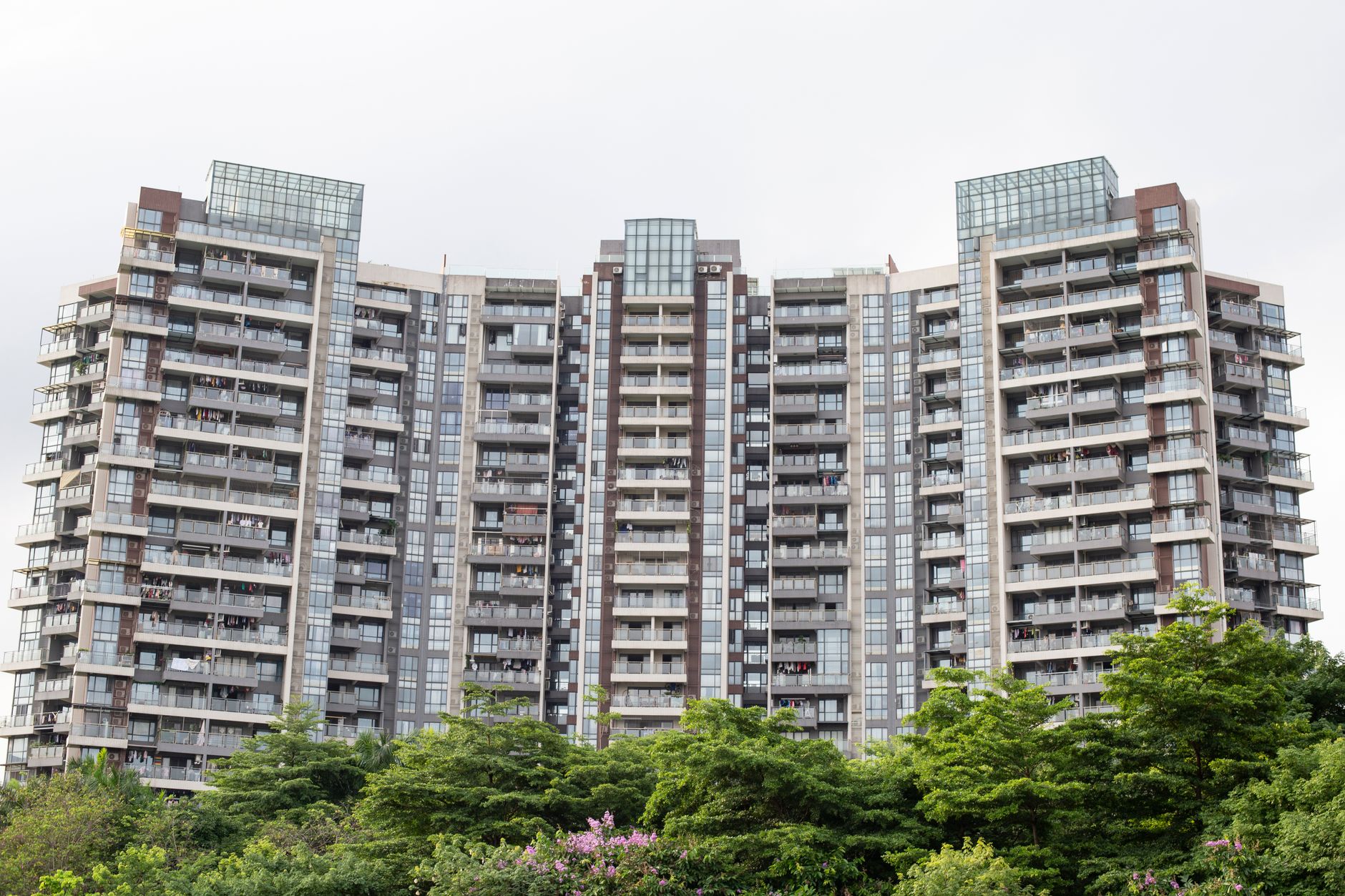 Contemporary high-rise buildings set against vibrant greenery, showcasing urban architecture and green spaces.