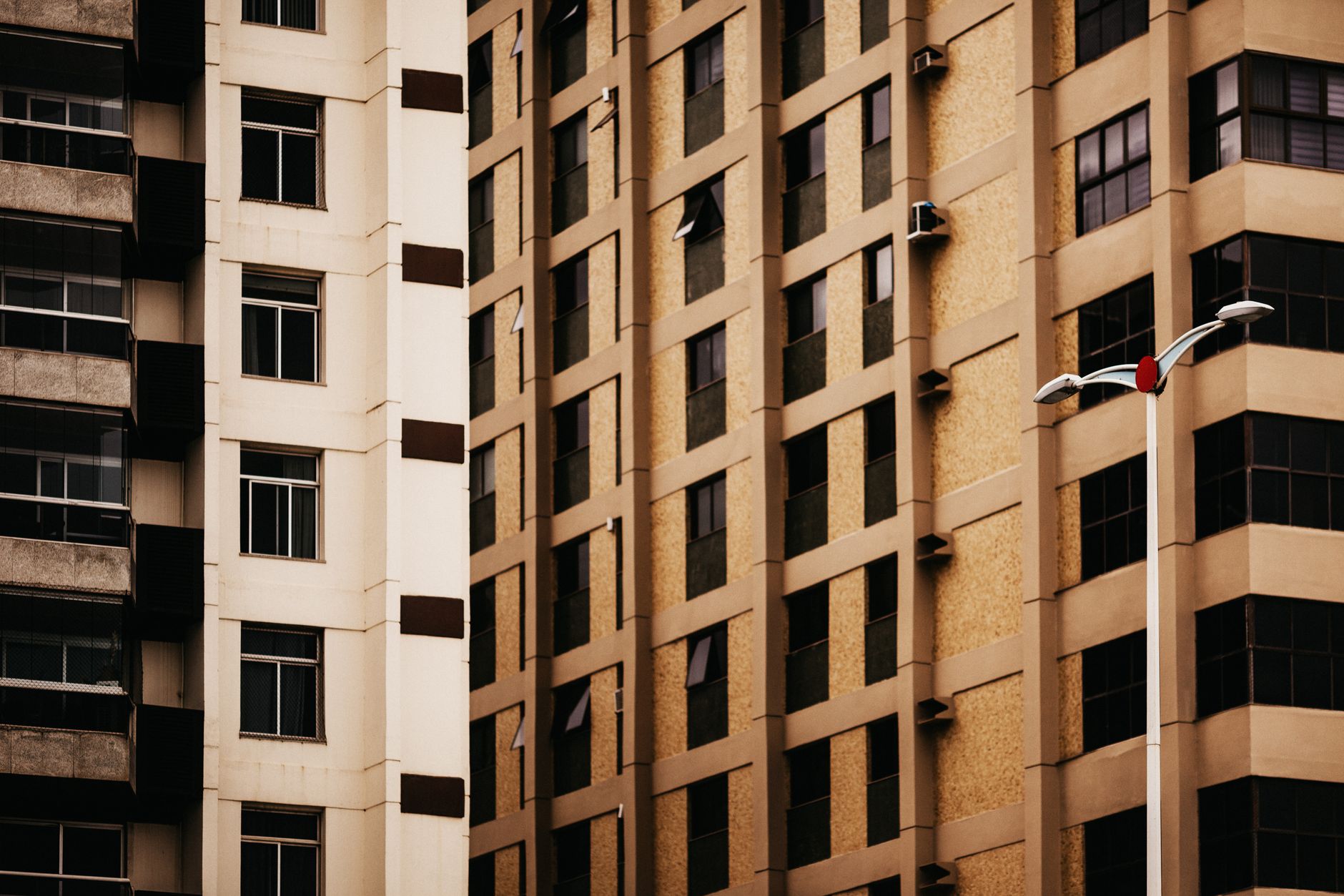 Close-up view of modern urban buildings showcasing geometric windows and patterns.