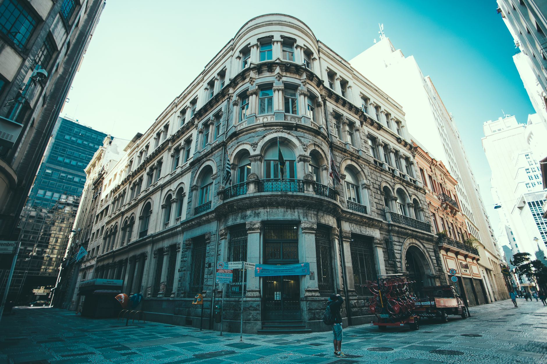 A majestic historic building stands in the heart of a vibrant downtown cityscape.