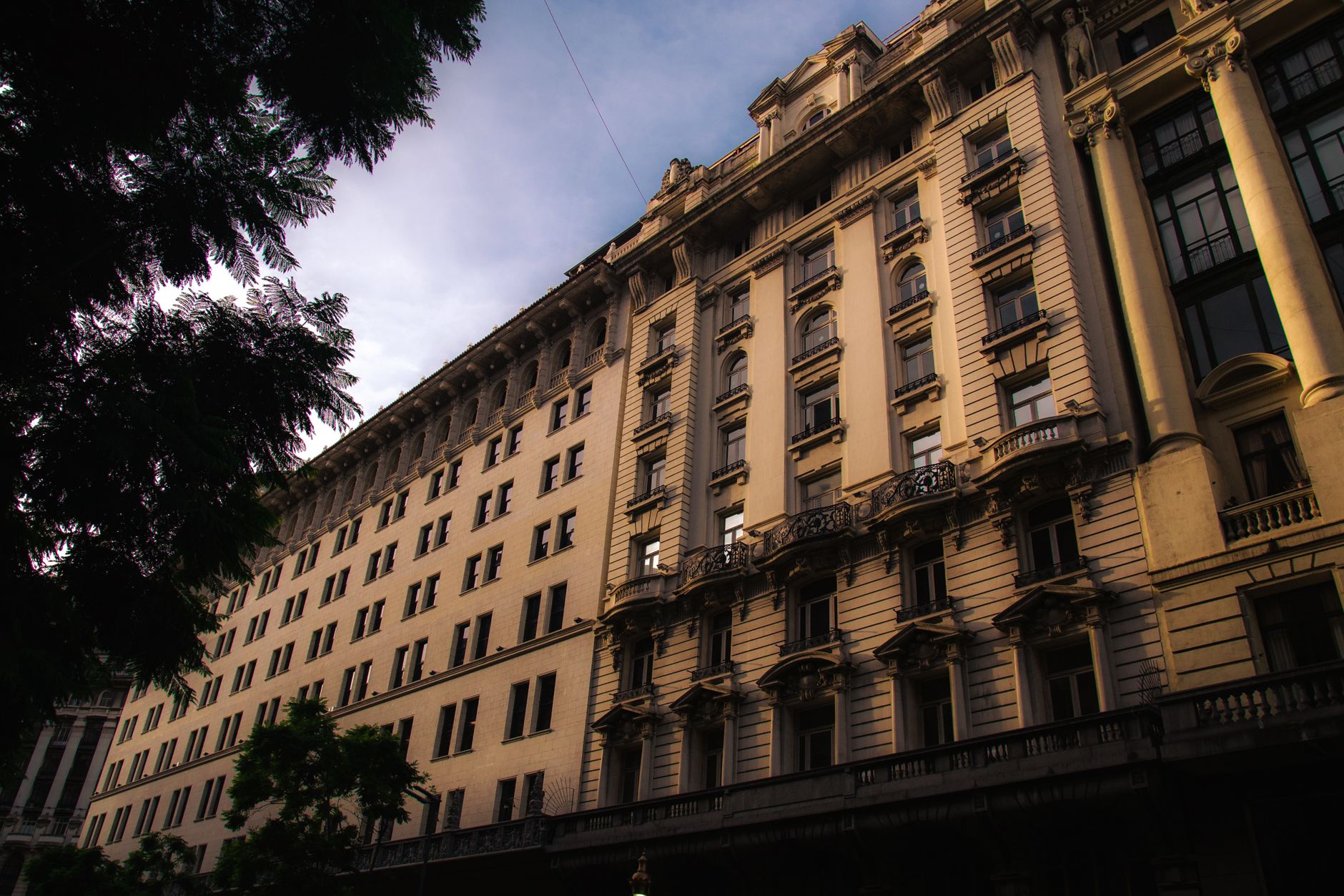 Capture of a grand historical building facade in Buenos Aires under a twilight sky.