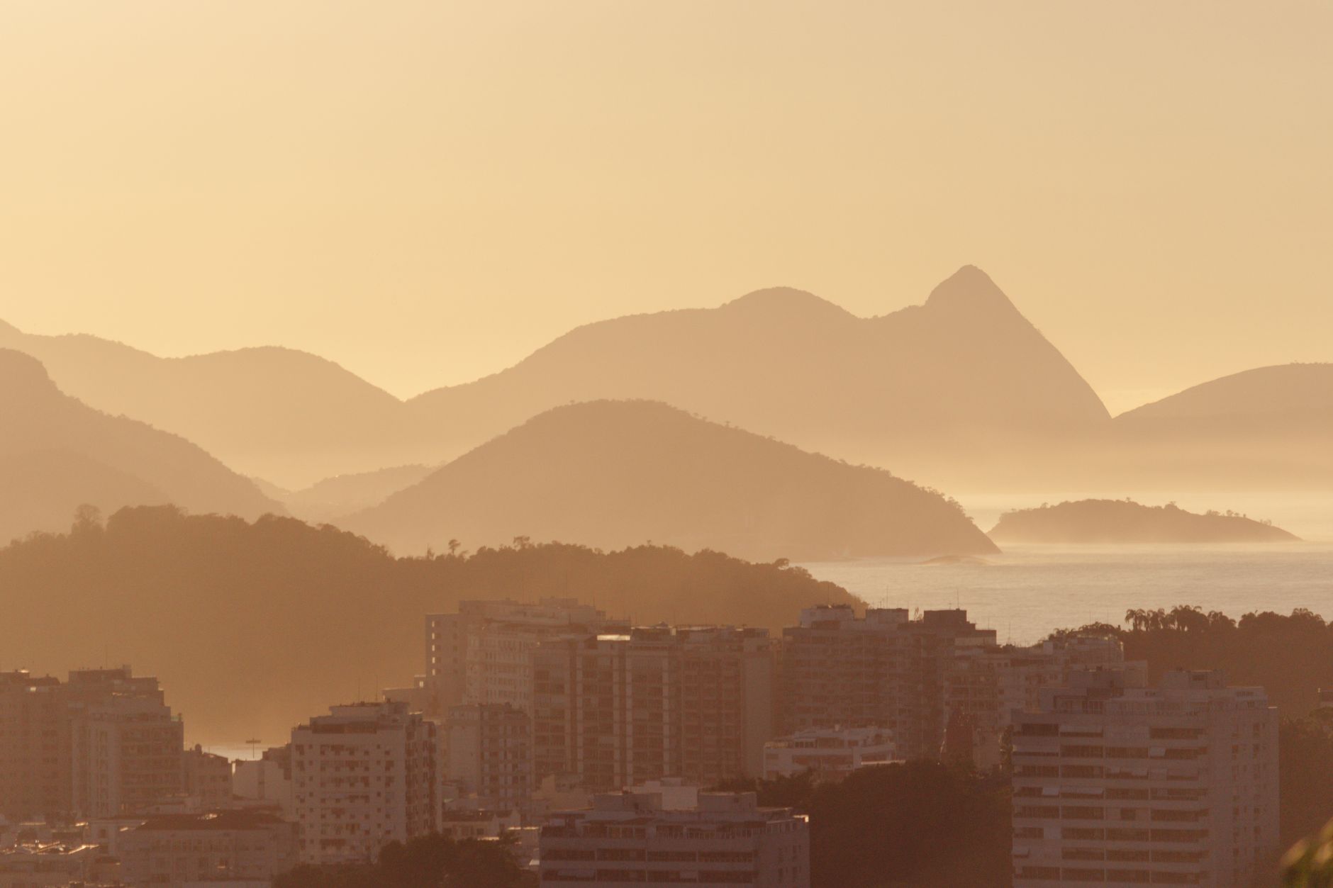 A serene misty morning view of Rio de Janeiro with mountains and cityscape.