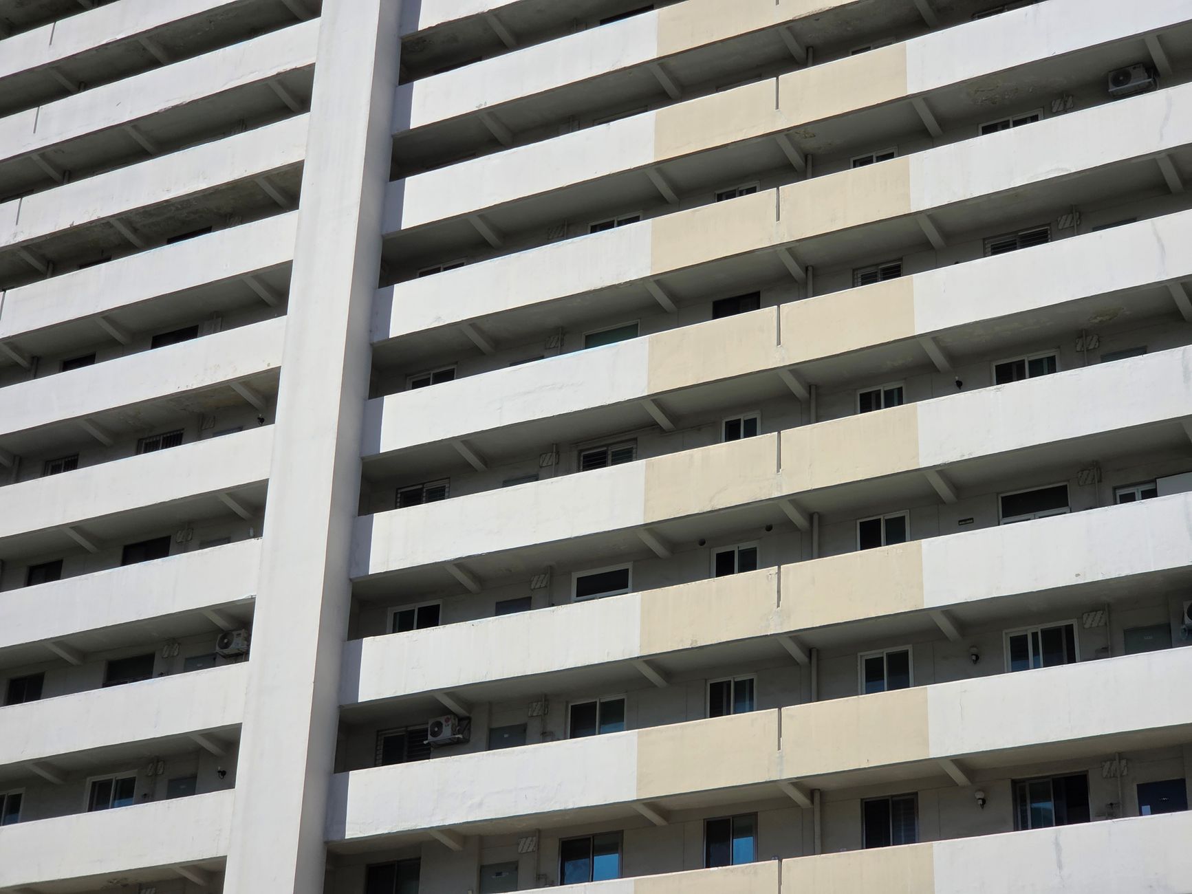 A modern high-rise apartment building facade with balconies in Seoul, South Korea.